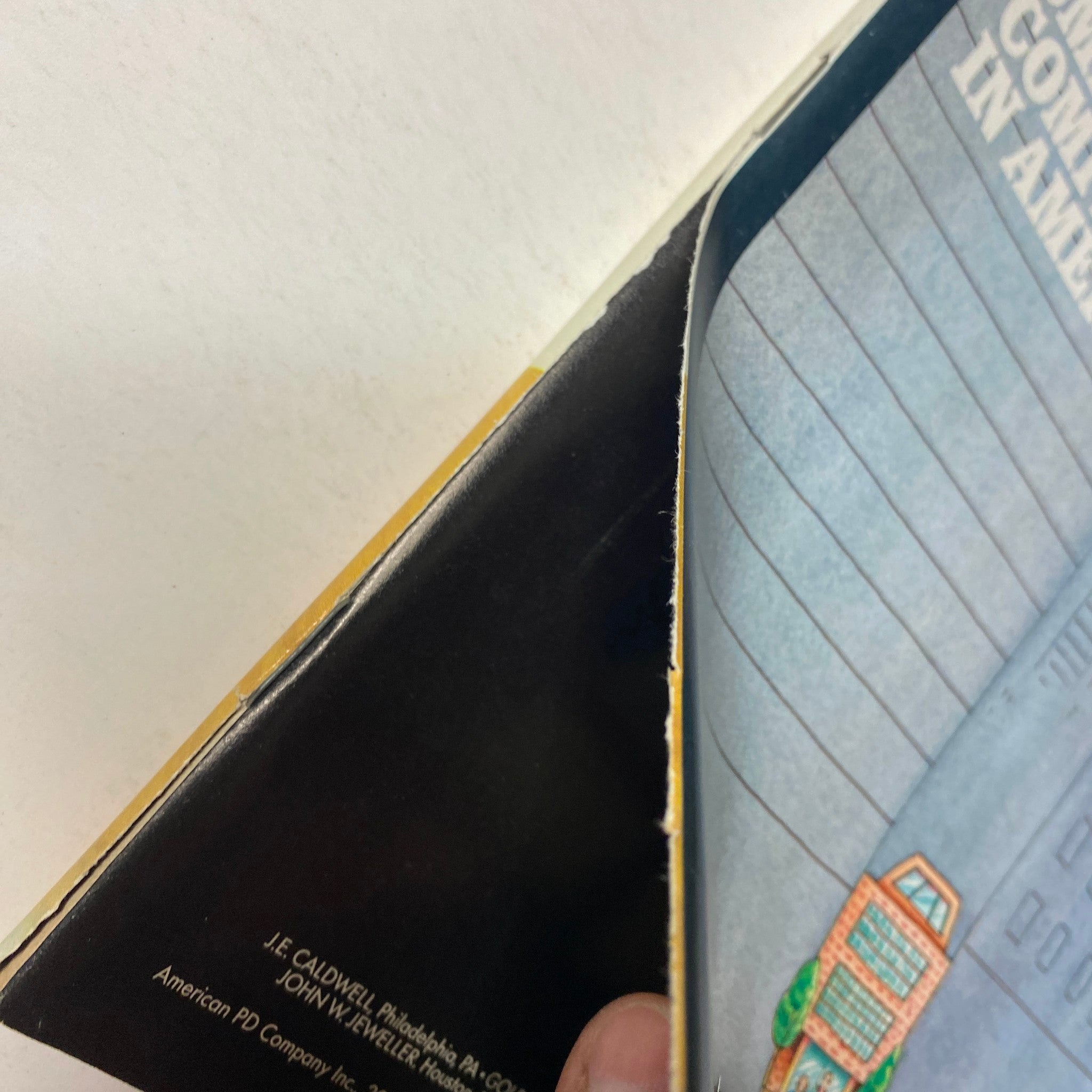 Close-up of the binding of Forbes Magazine, November 4, 1985, showing wear and a blurred address label, highlighting its vintage nature.