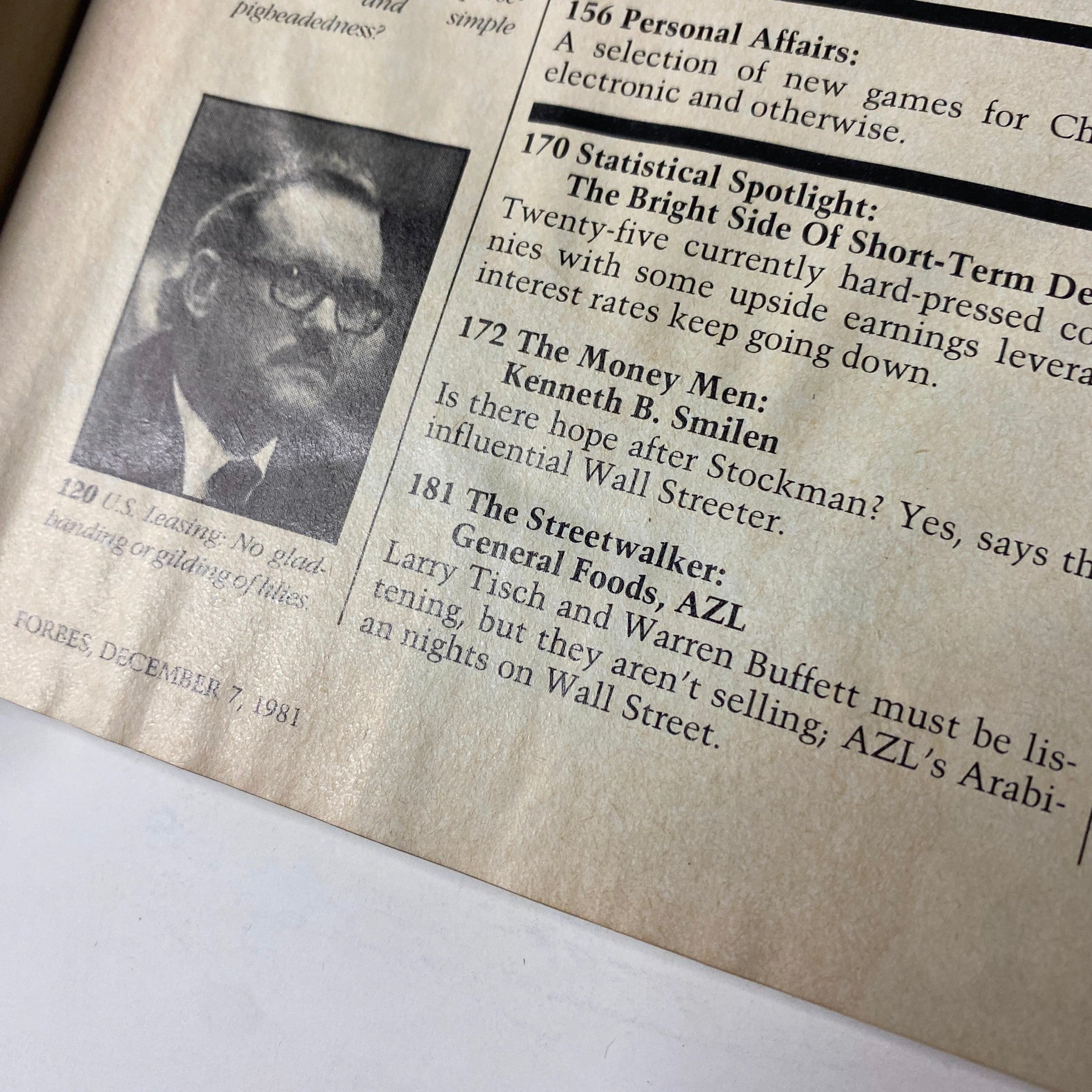 Close-up of a section from Forbes Magazine December 7, 1981, highlighting articles on finance and notable figures like Kenneth B. Smilen.