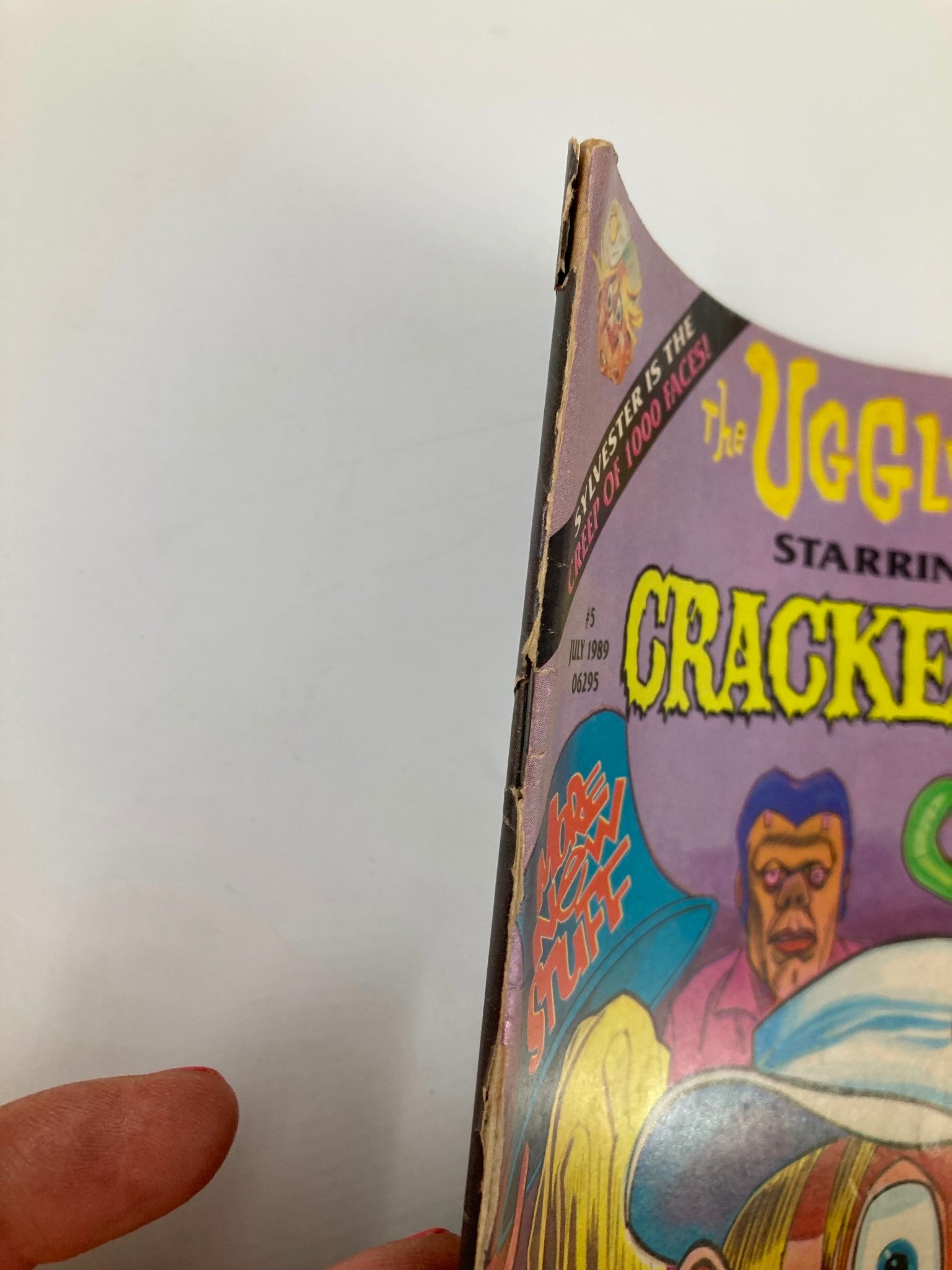 Side view of Cracked Humor Magazine July 1989 showing minor wear and tear, highlighting the vintage nature of the publication.