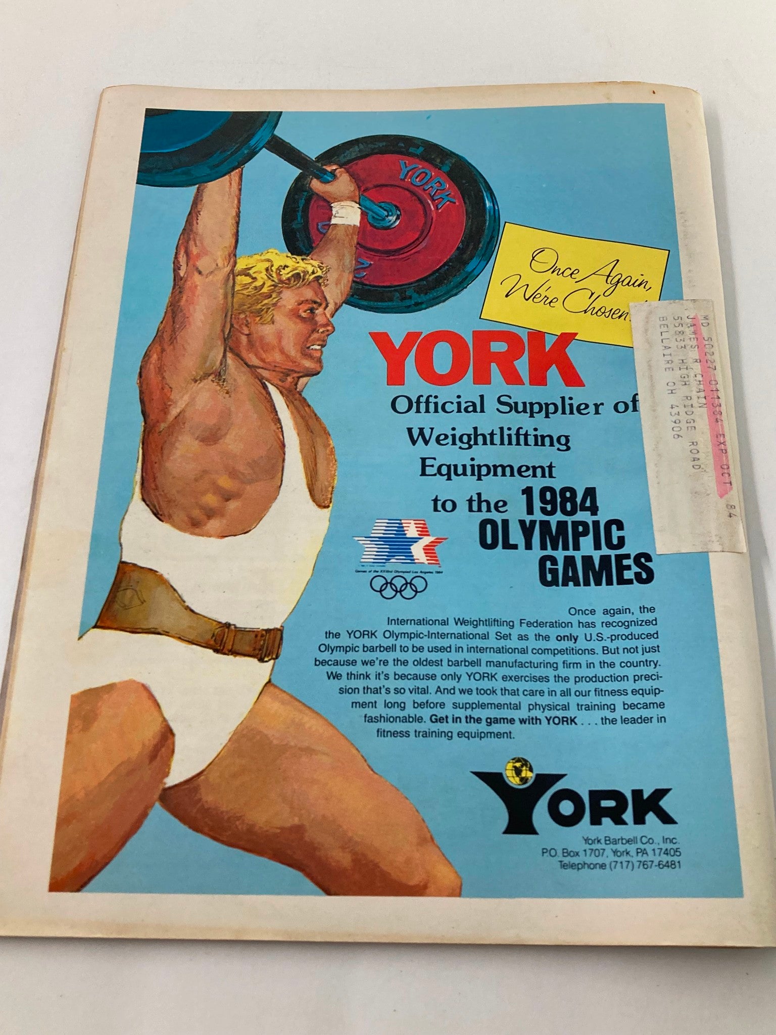 Cover page advertisement for York Barbell in the VTG Muscular Development Magazine June 1984 Vol 21 #3, showcasing a weightlifter with the York logo, promoting weightlifting equipment for the 1984 Olympic Games.