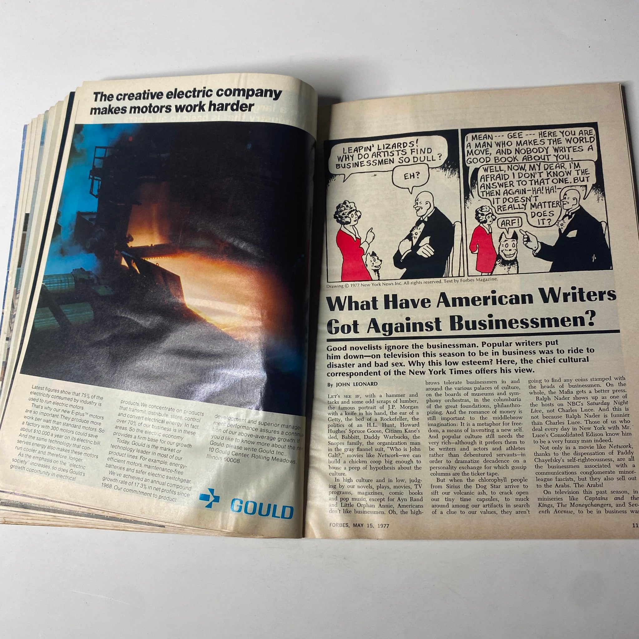 Another interior page from Forbes Magazine May 15, 1977 discussing American writers’ perspective on business people, alongside an advertisement for Gould, showcasing insights into business culture during the 1970s.