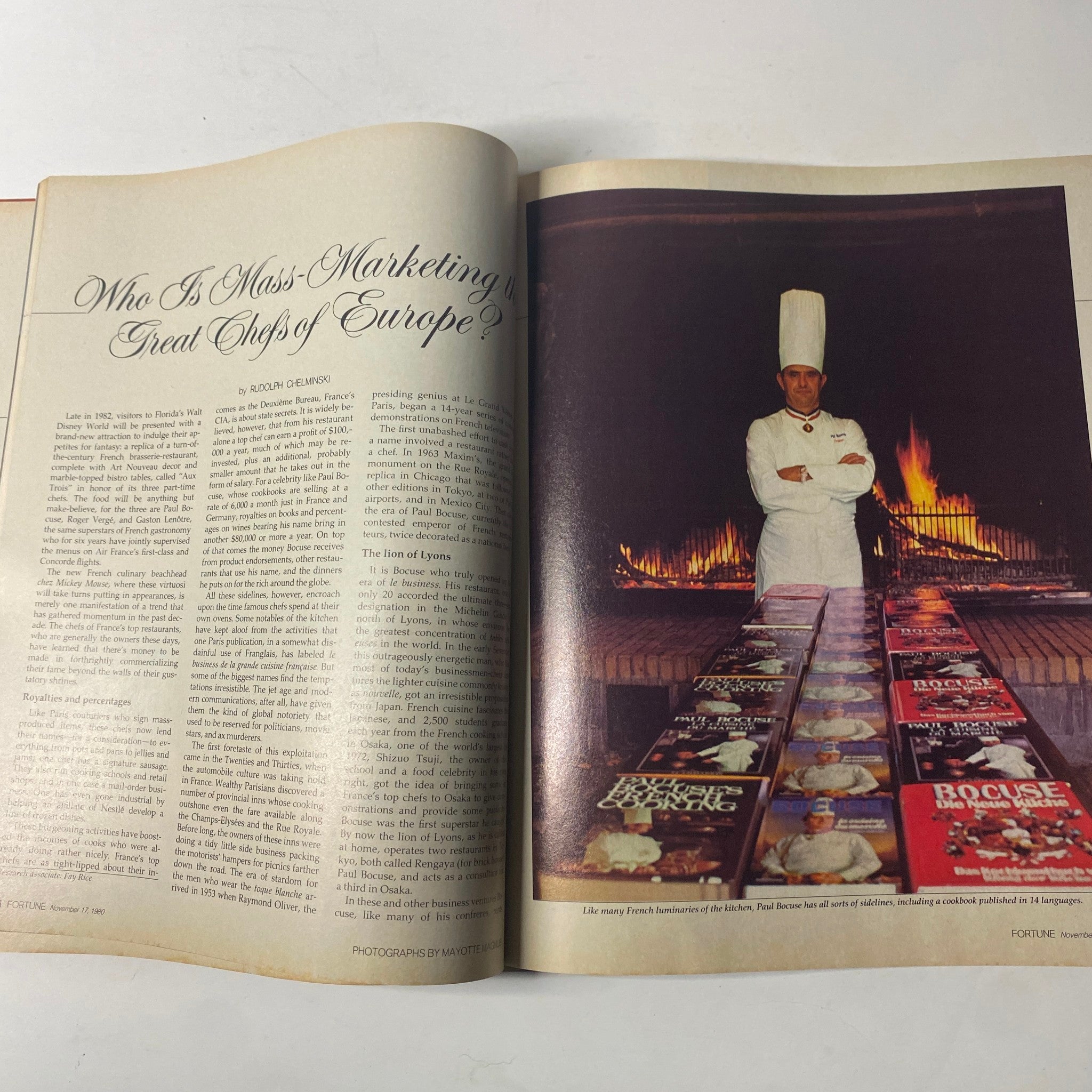 Two-page spread in Fortune Magazine, November 17, 1980, featuring a chef standing proudly in front of a large fireplace surrounded by culinary books. The article discusses the rise of French chefs and their influence on gastronomy.