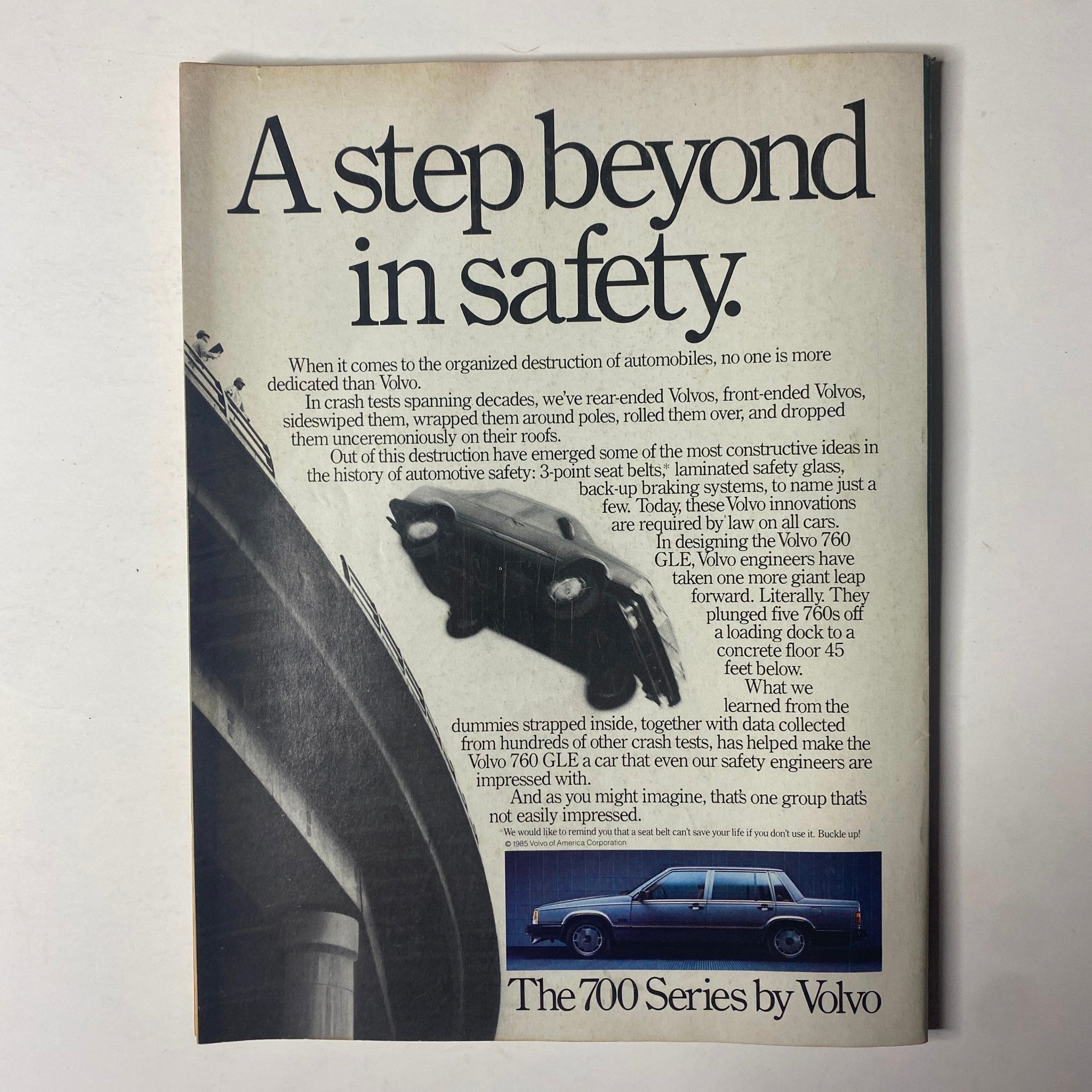 Vintage advertisement from Forbes Magazine July 29, 1985 featuring the Volvo 700 Series. The ad emphasizes automotive safety innovations including 3-point seat belts and standard safety features, illustrated with images of the Volvo 760 GLE. A compelling look at Volvo's commitment to safety technology in the context of the 1985 global shipping disaster.