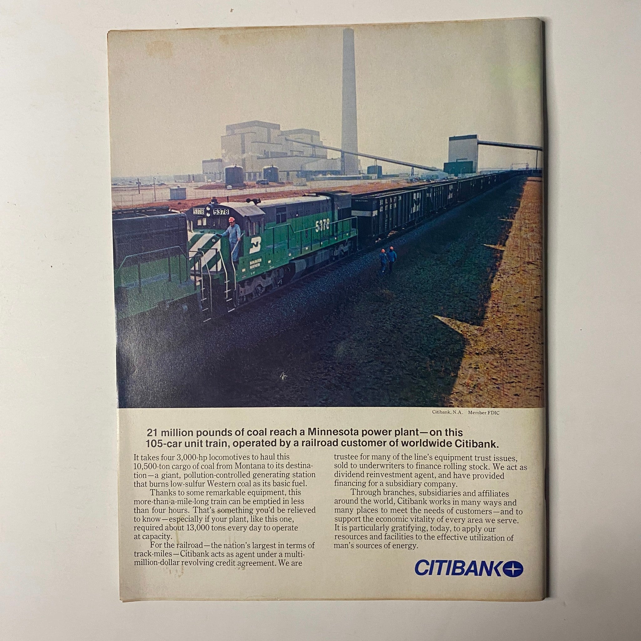 Advertisement page from Forbes Magazine, July 1, 1977, highlighting Citibank services related to coal transportation, showcasing an image of a train loaded with coal.
