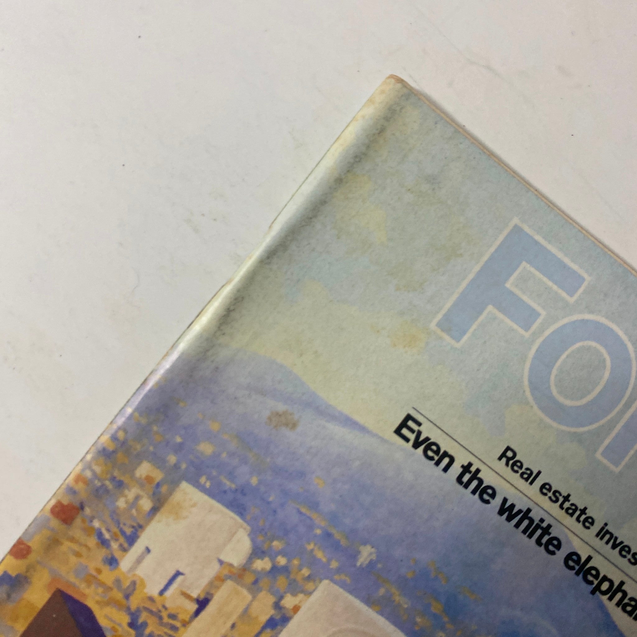 Close-up view of the corner of Forbes Magazine December 1, 1977, showcasing the title 'Real Estate: The REITs Get Better' and background illustration of a cityscape.