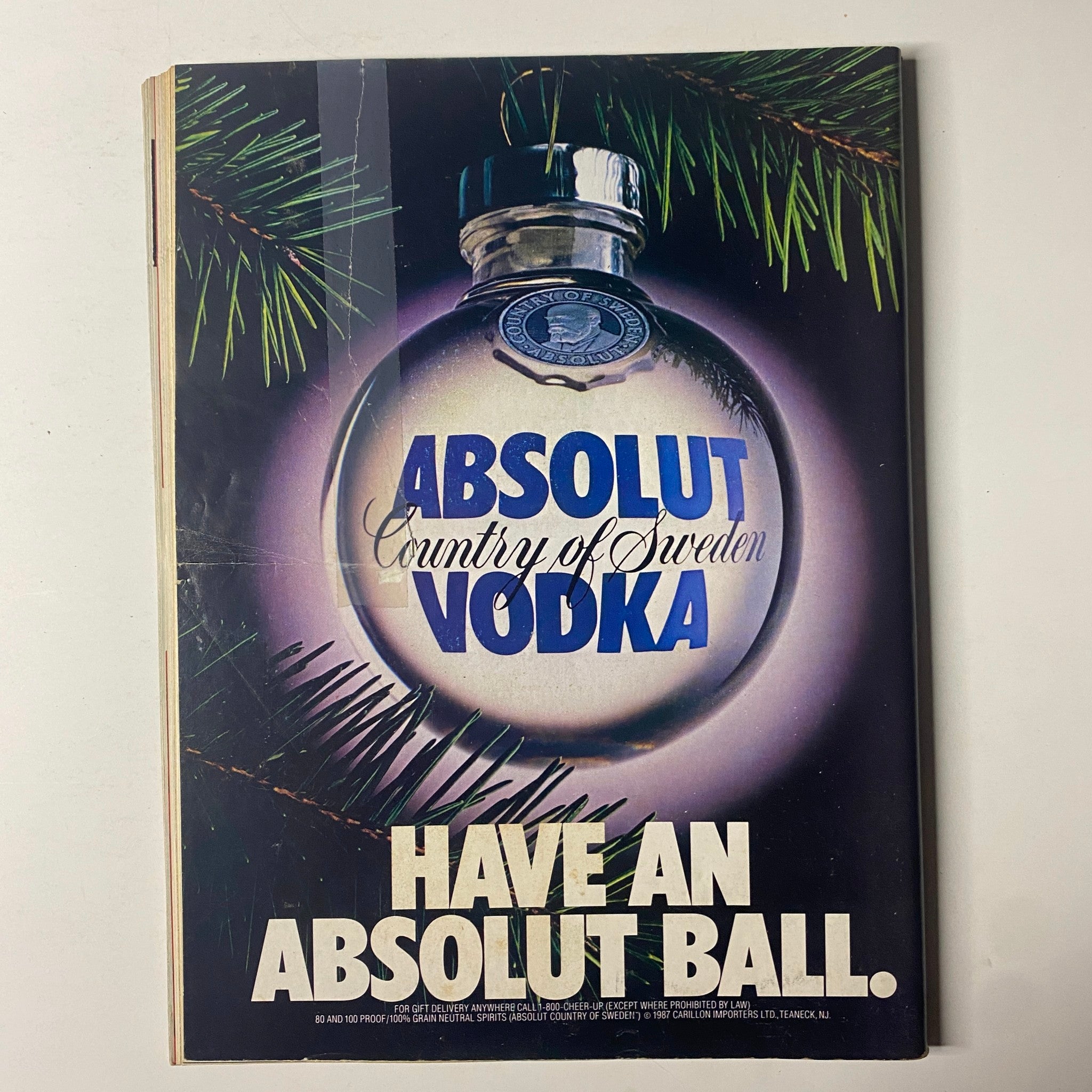 Advertisement page from Forbes Magazine December 14, 1987, featuring a visually striking Absolut Vodka ad with seasonal decoration.