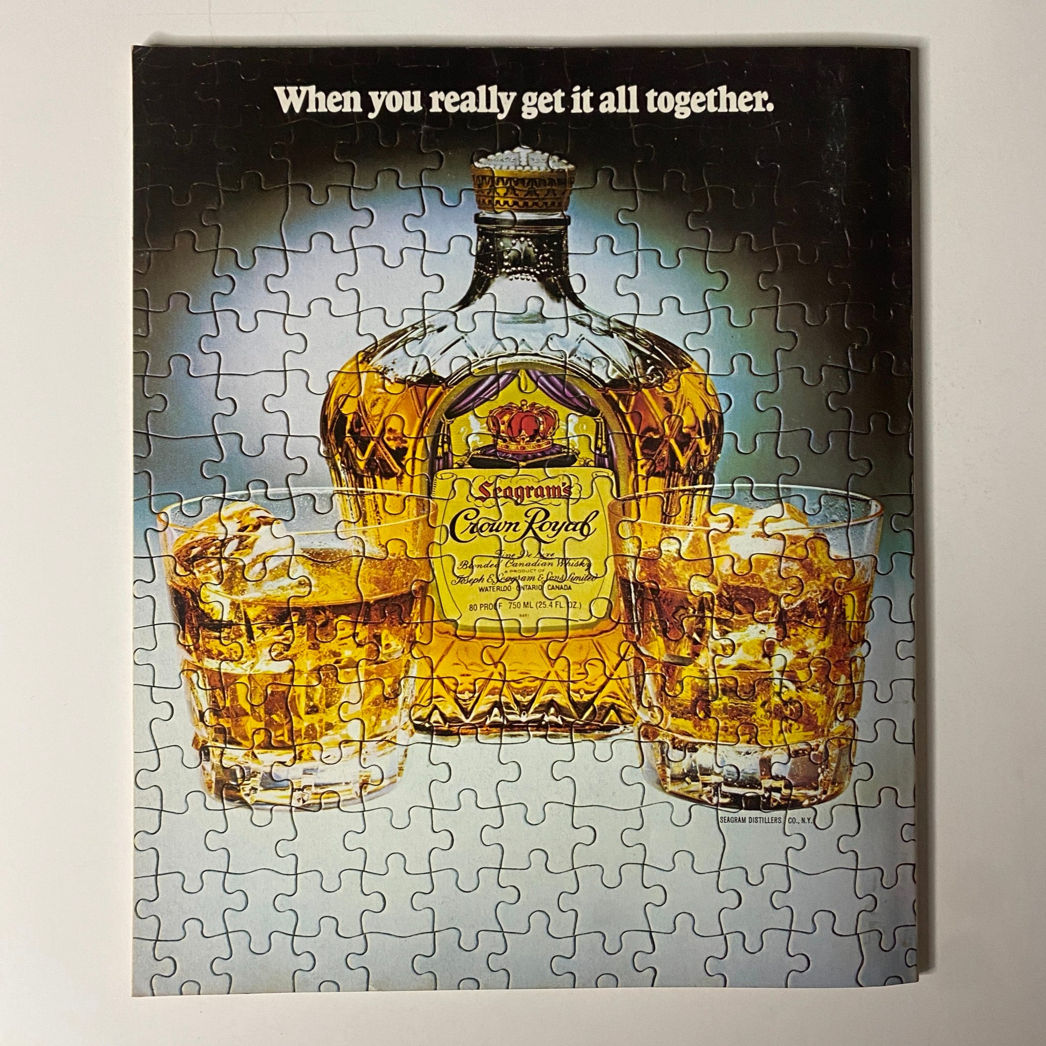 Image of a vintage puzzle featuring a Crown Royal whiskey bottle and two glasses filled with whiskey, accompanied by the text 'When you really get it all together' from Fortune Magazine's July 2, 1979 issue titled 'Television's Widening World'.