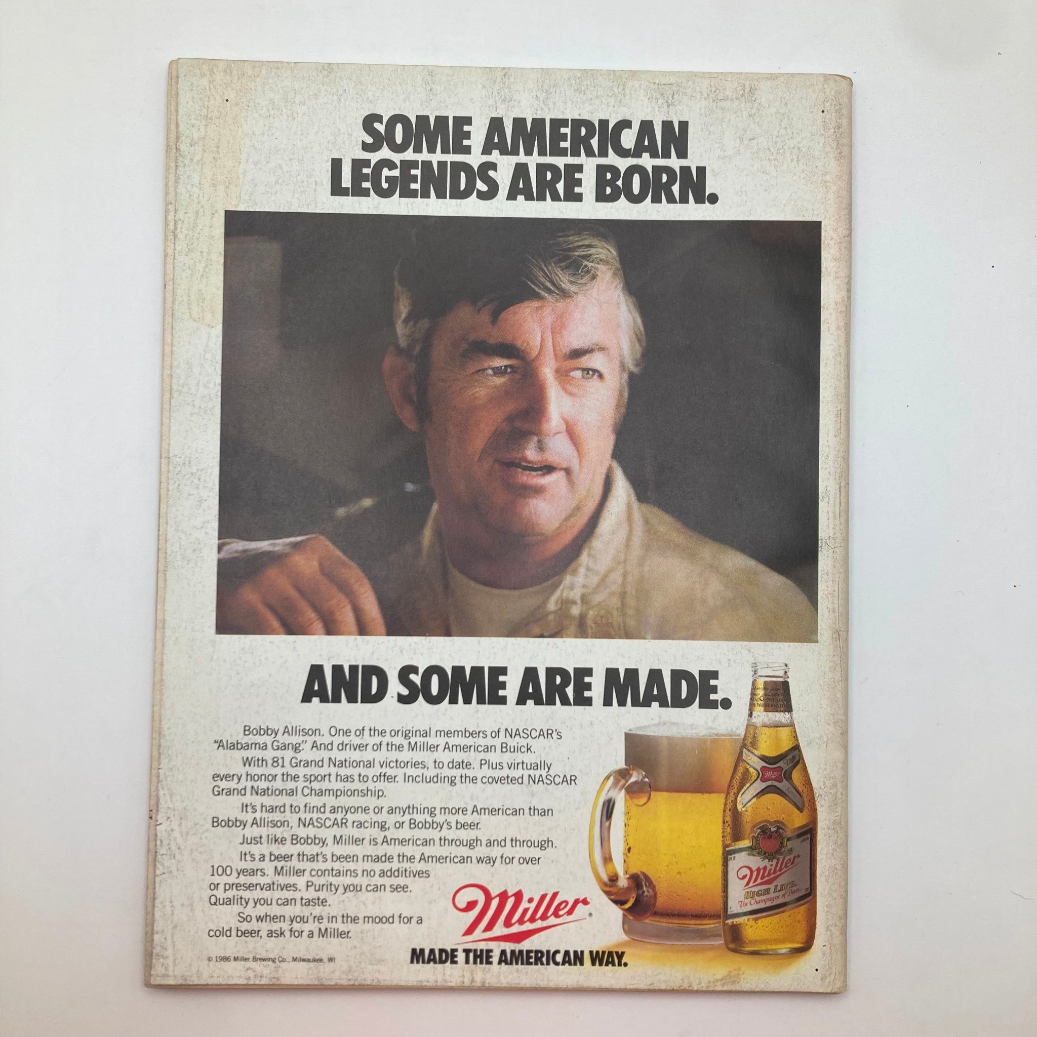 Back cover of the Vintage Stock Car Racing Magazine April 1986 featuring an advertisement for Miller Beer and a portrait of Bobby Allison, famed NASCAR driver.
