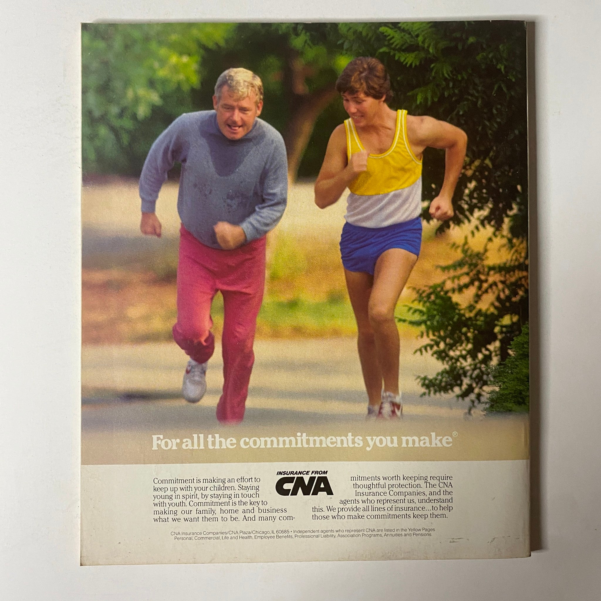 Back cover of Fortune Magazine January 21, 1985, showcasing a colorful advertisement for CNA Insurance with two men jogging.