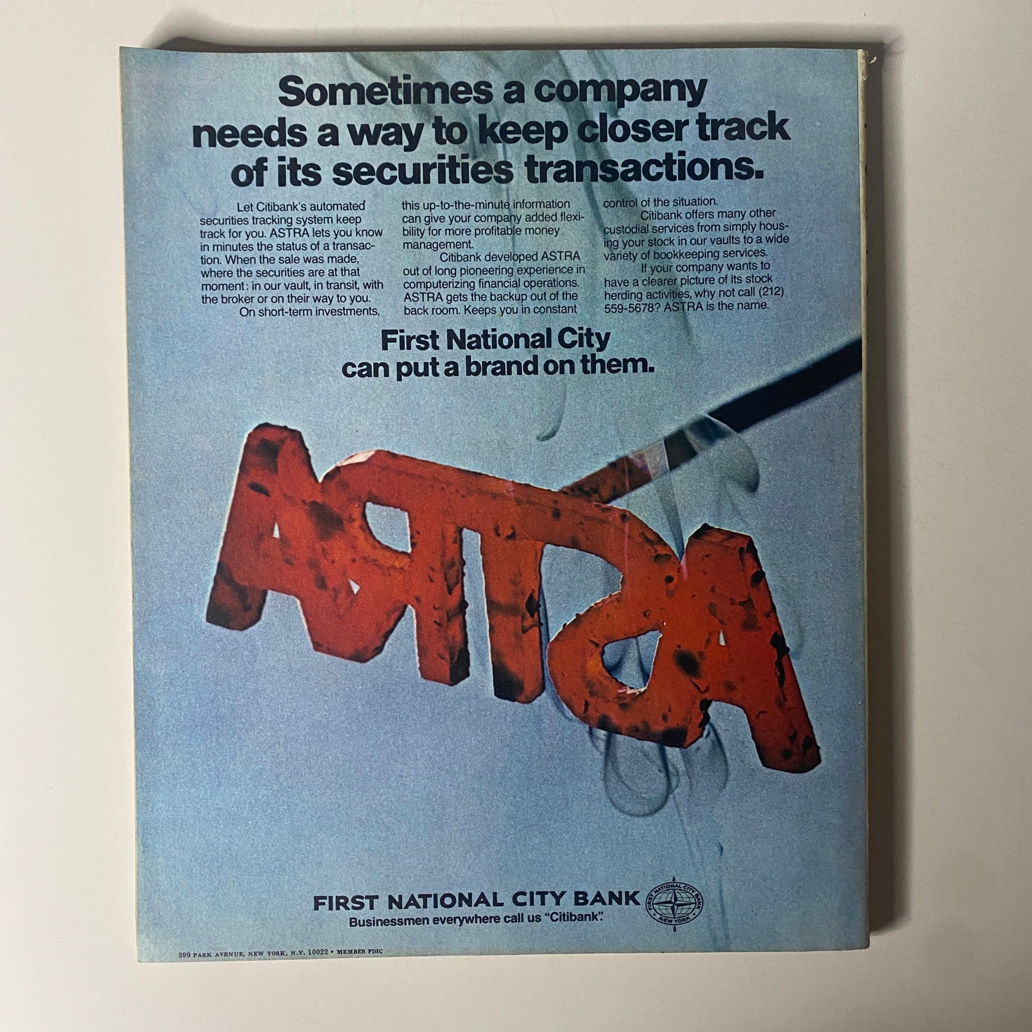 Vintage advertisement from Fortune Magazine October 1972 showcasing First National City Bank's ASTRA system for tracking securities transactions. The ad emphasizes the importance of real-time information for corporate finances, featuring bold text and striking design elements.