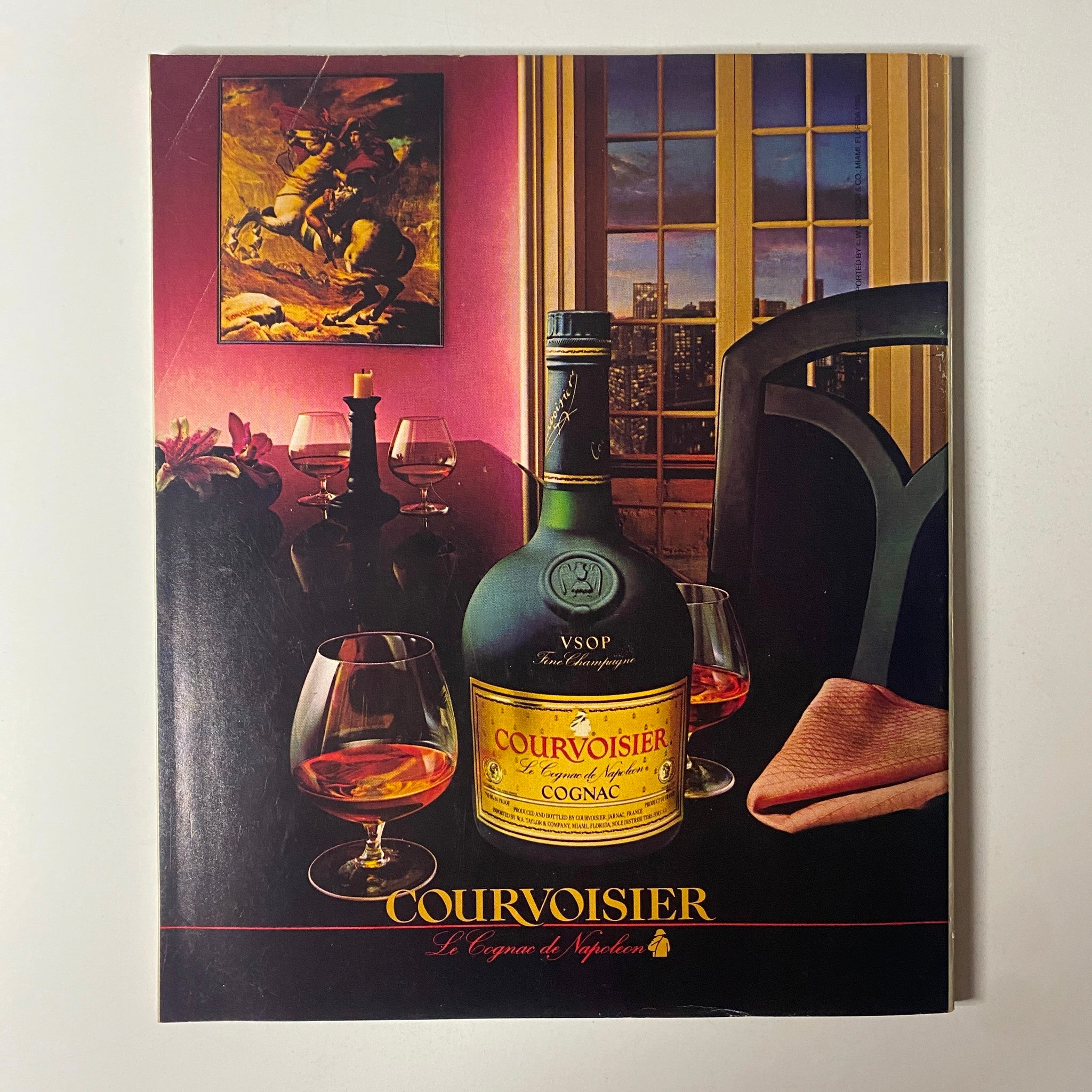 Advert for Courvoisier cognac featured in Fortune Magazine December 9, 1985, showcasing a bottle of VSOP cognac and two glasses in a sophisticated setting.