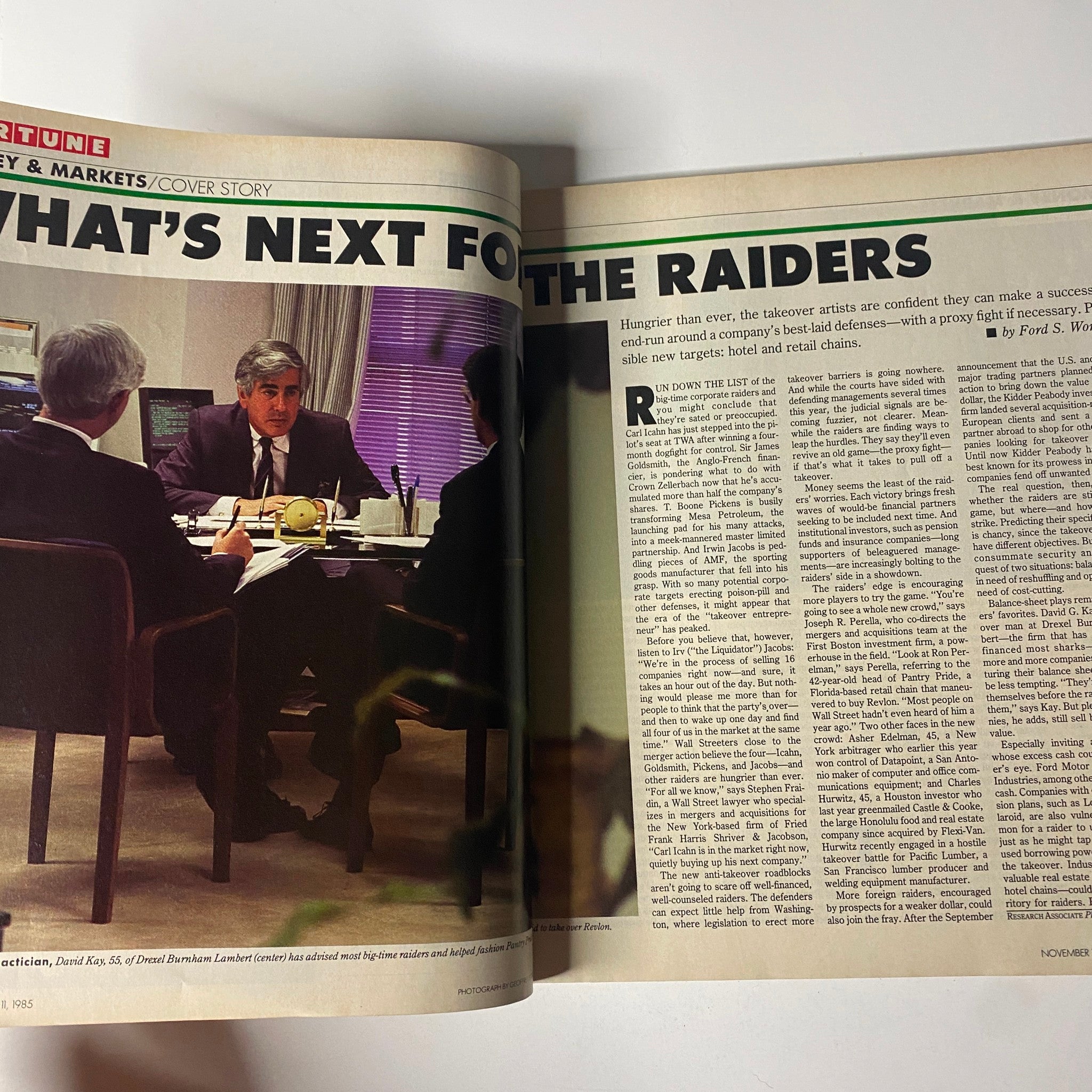 Feature article titled 'What's Next for The Raiders' in Fortune Magazine, November 11, 1985, depicting a business meeting scenario related to corporate raiders.