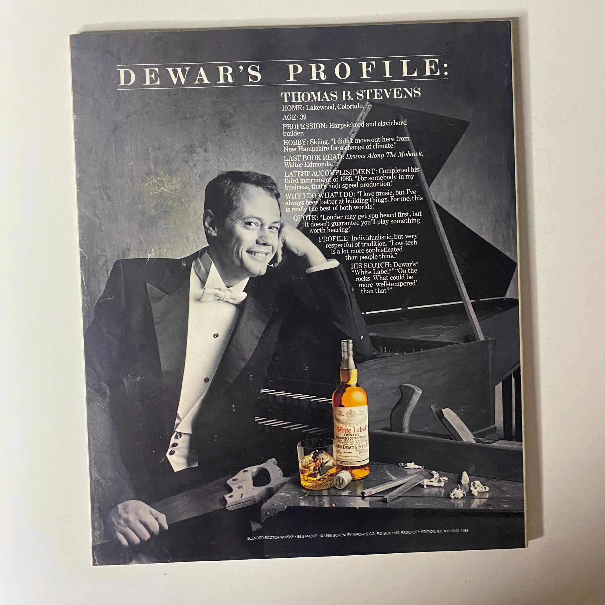 Back profile page from Fortune Magazine November 1985, featuring Thomas B. Stevens profile along with an advertisement for Dewar's whiskey.