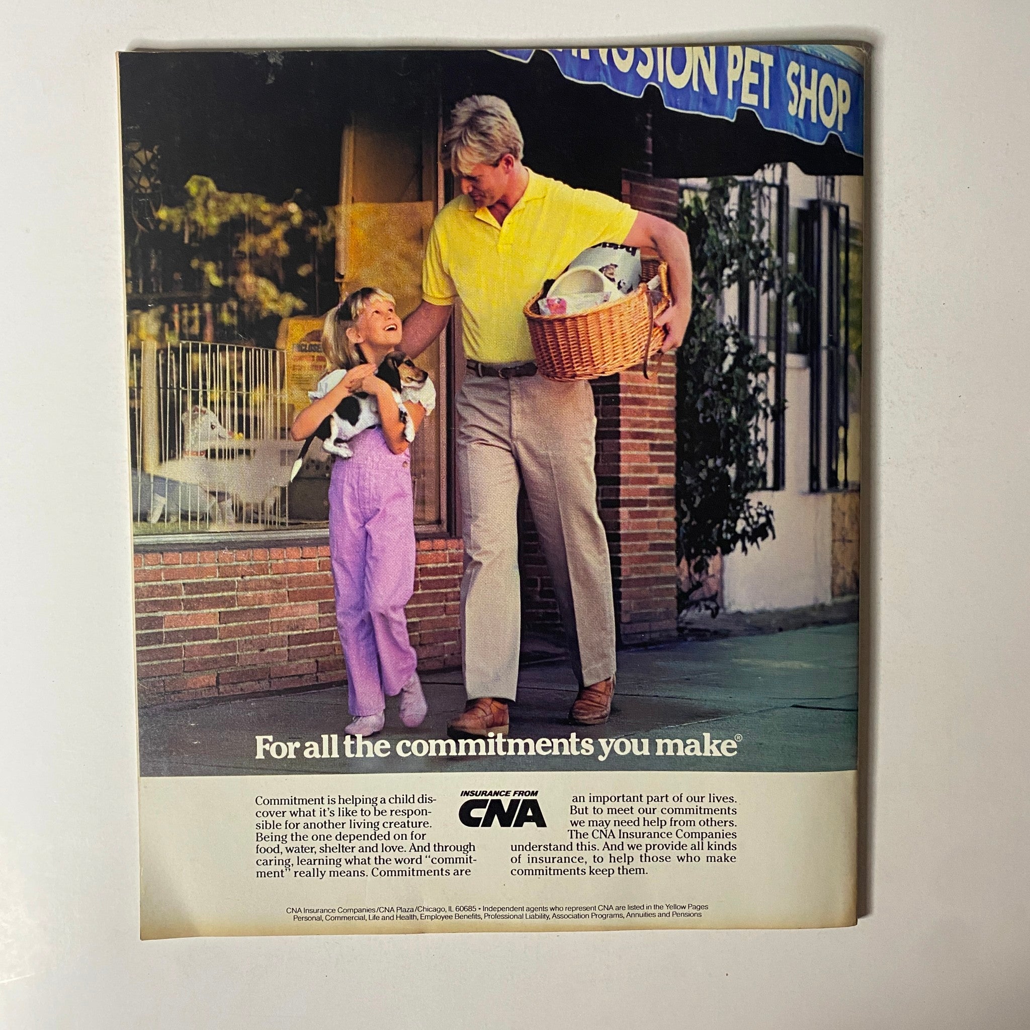 Vintage advertisement from Fortune Magazine September 2, 1985, depicting a man and a girl with a kitten, promoting commitments and responsibility in life.