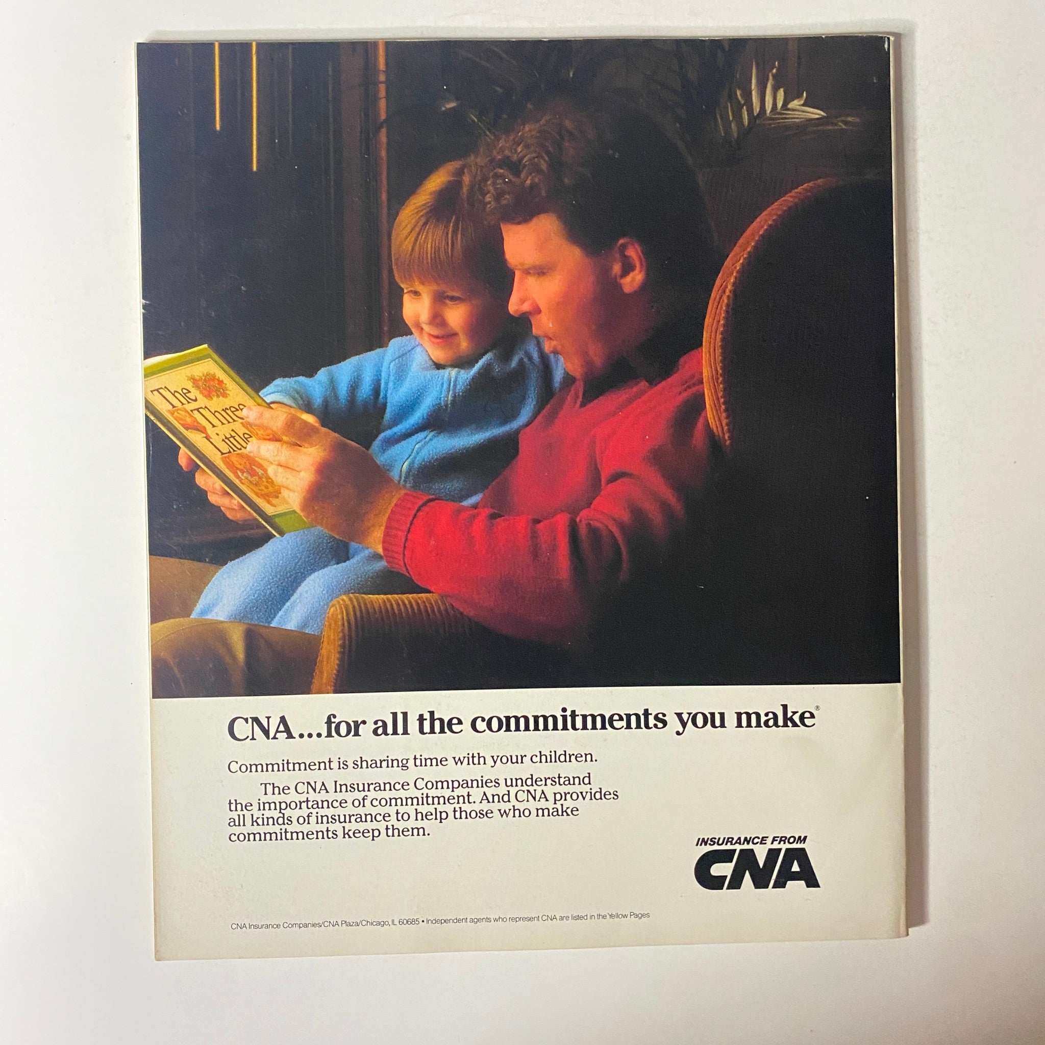 Fortune Magazine May 12, 1986 advertisement for CNA Insurance featuring a father reading to his child, illustrating family commitment and the importance of insurance protection.