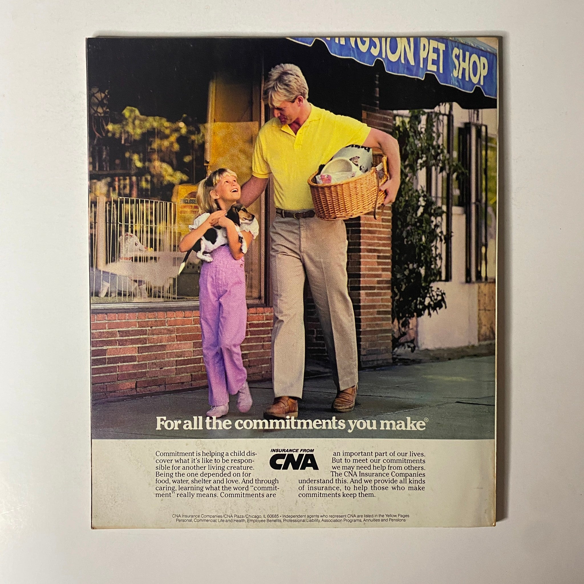 Vintage advertisement featuring a man and a girl with a puppy outside a pet shop, promoting commitments from CNA insurance, relating to the caring for pets and responsibilities, associated with the article 'Fortune Magazine January 6, 1986 America's Most Admired Corporations'.