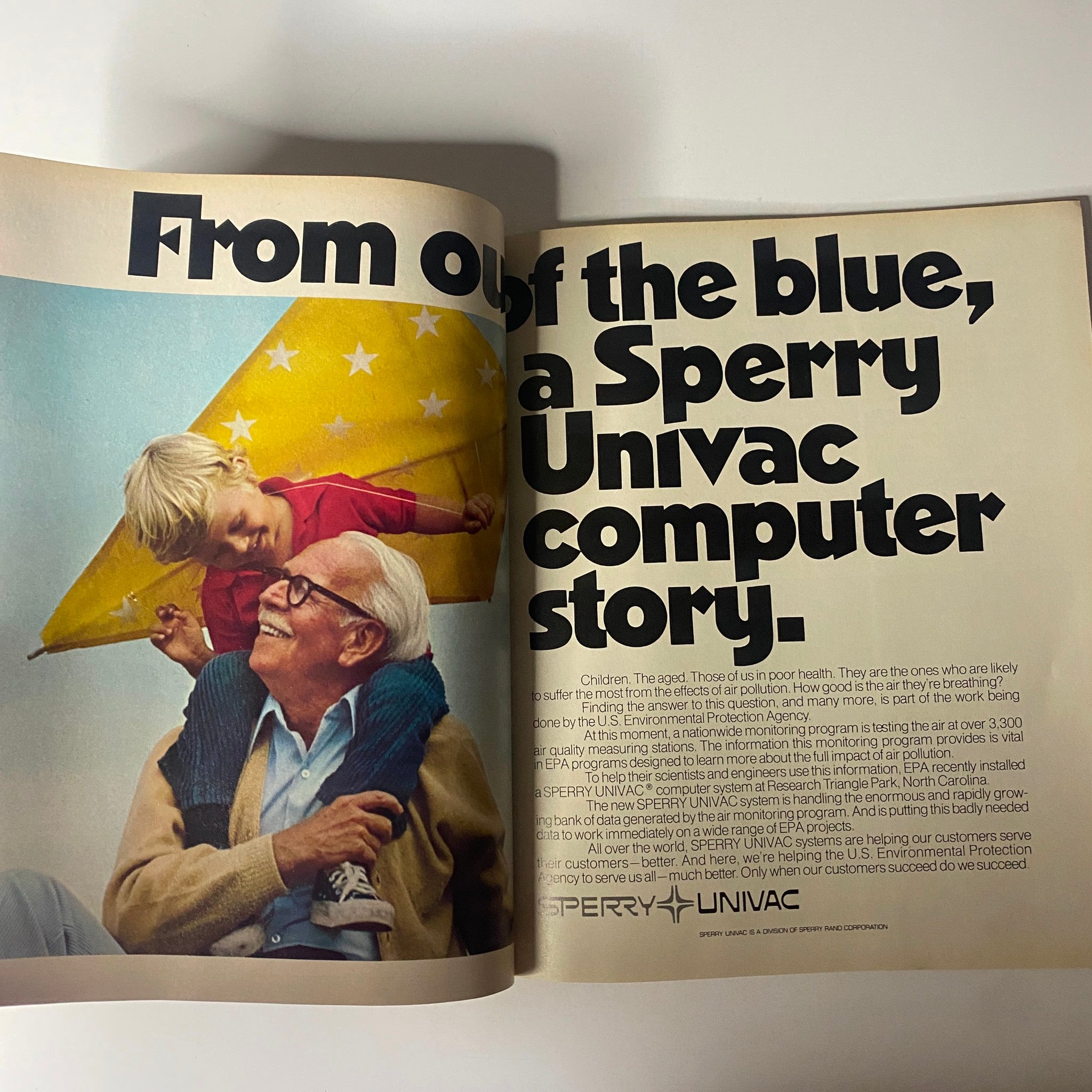 A vintage magazine spread from Fortune Magazine March 1977 titled 'From out of the blue, a Sperry Univac computer story.' The image features a grandfather and a child with a colorful kite. This issue explores technology and its impact on health and environment.