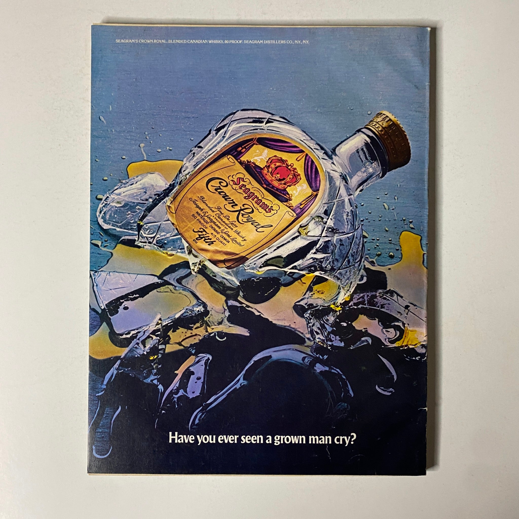 Cover of Esquire Magazine May 1977 featuring an advertisement for Seagram's Crown Royal whiskey with the tagline 'Have you ever seen a grown man cry?'. This vintage magazine explores themes of friendship and culture.