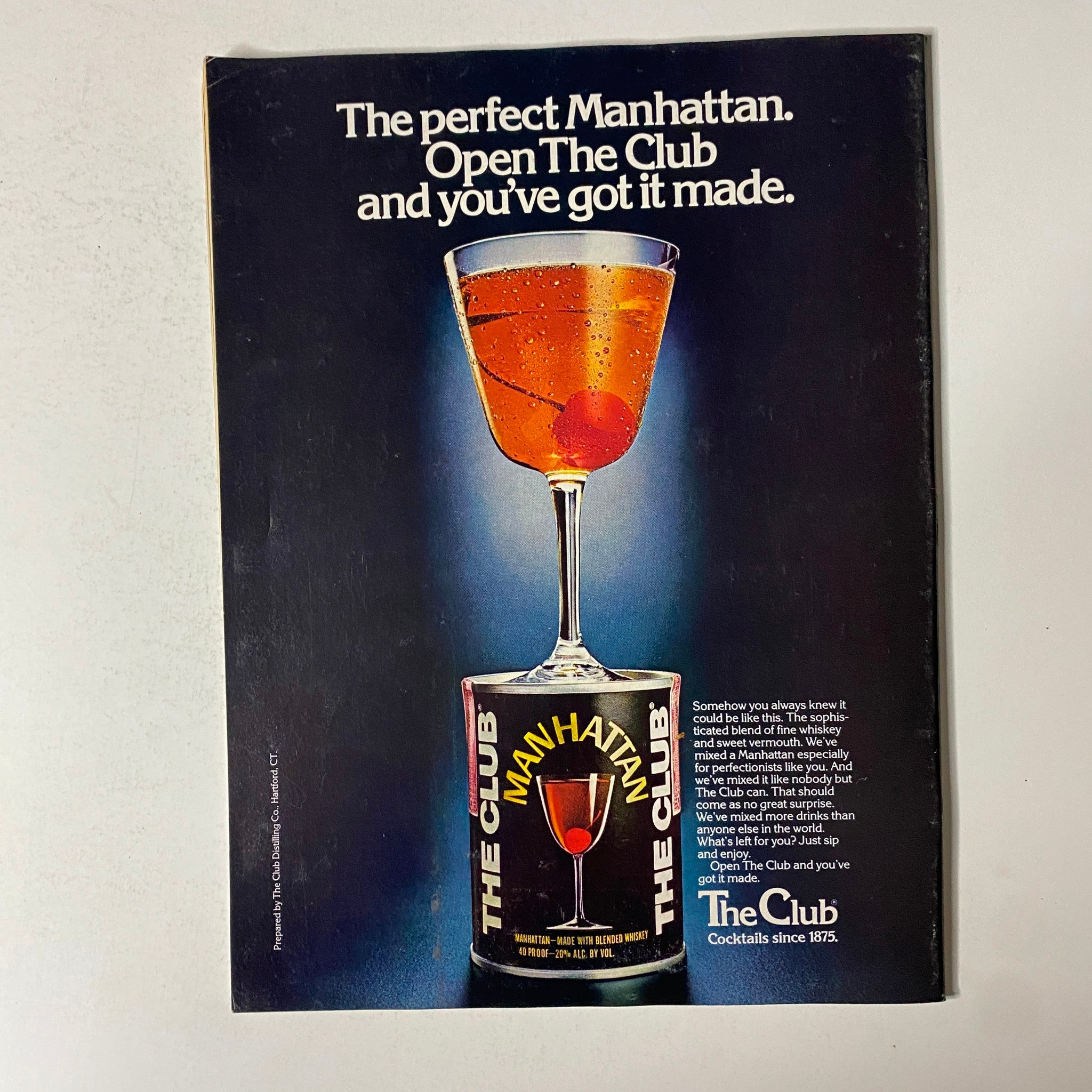 Advertisement for 'The Club' featuring a cocktail Manhattan, found in Esquire Magazine February 27, 1979, promoting a sophisticated drink experience.
