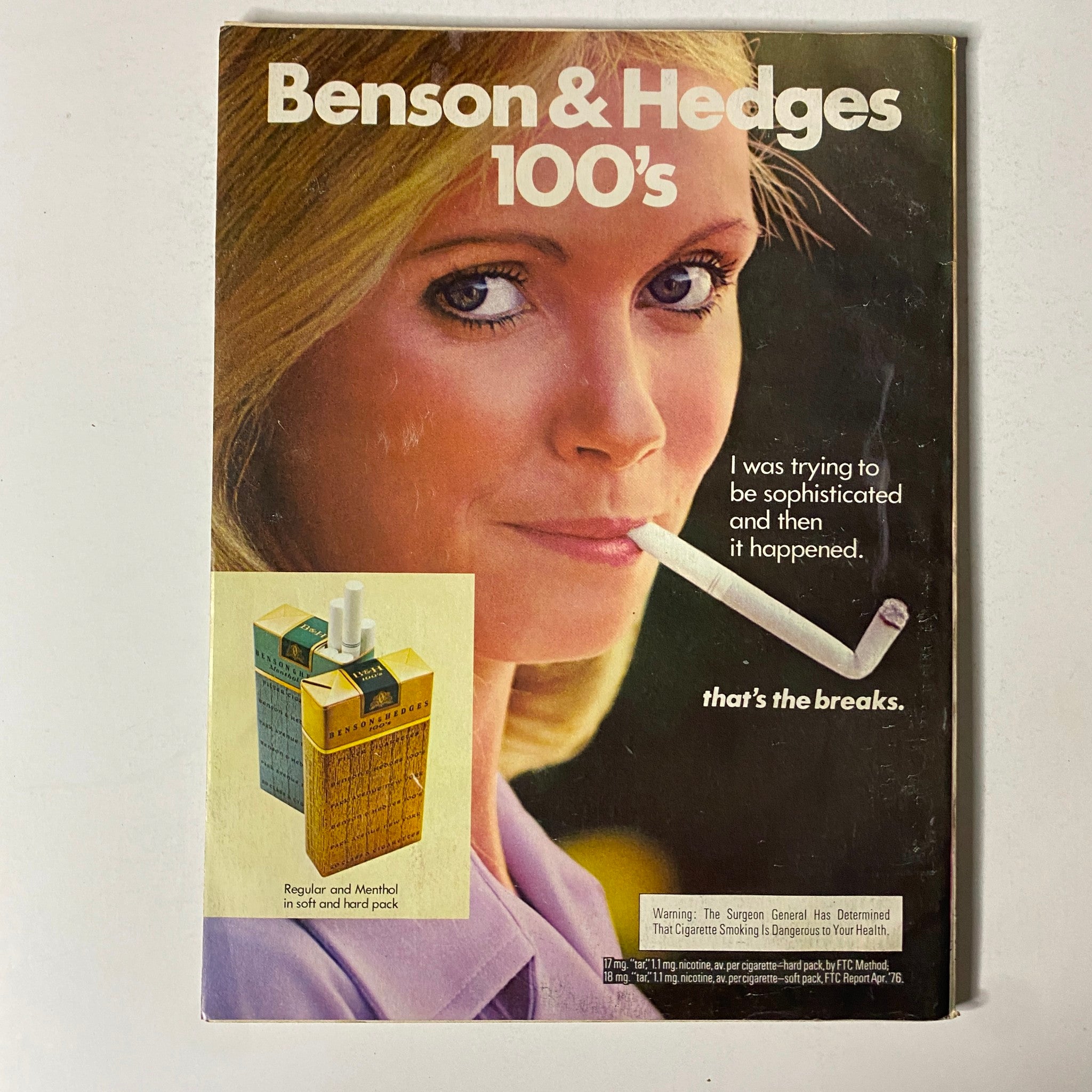 Advertisement for Benson & Hedges 100's cigarettes in Esquire Magazine March 1977, featuring a woman with a cigarette. This reflective ad highlights advertising trends related to tobacco in the magazine's vintage context.