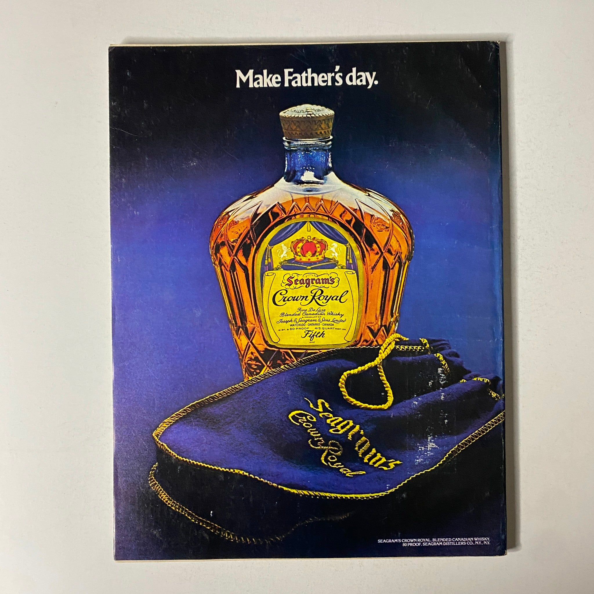 Advertisement from Esquire Magazine June 1977 for Seagrams Crown Royal, promoting a whiskey gift idea with a vibrant visual showcasing the bottle and branding.