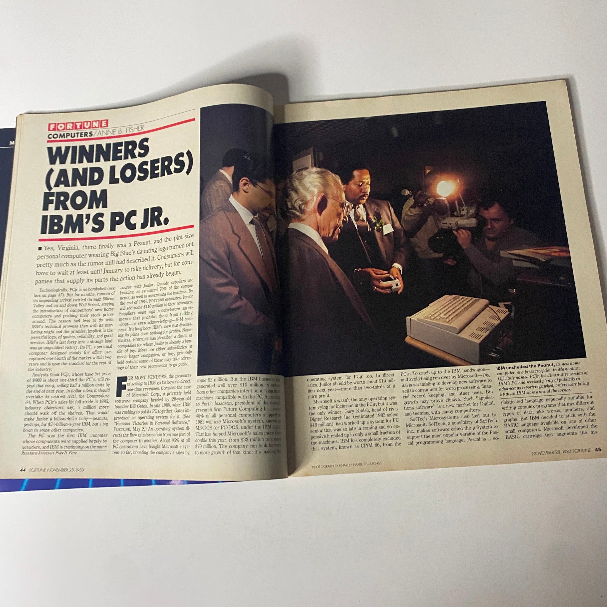 Inside view of Fortune Magazine from November 28, 1983, illustrating the article titled 'Winners (and Losers) From IBM's PC Jr.' with a photograph from an event showcasing IBM's PC Jr.