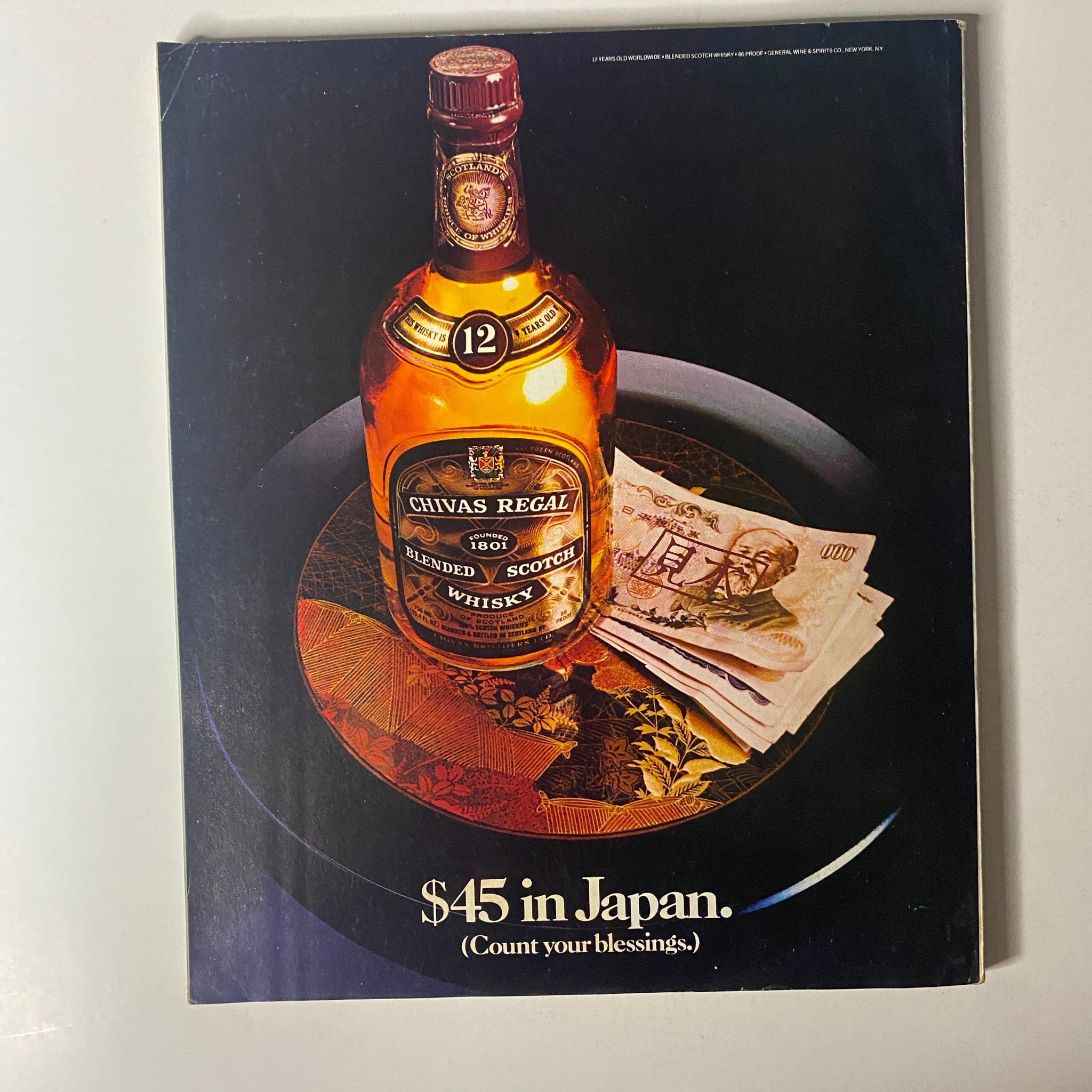 Advertisement from Fortune Magazine dated November 14, 1983, featuring a bottle of Chivas Regal whisky with a price tag of '$45 in Japan,' highlighting luxury and international trade.