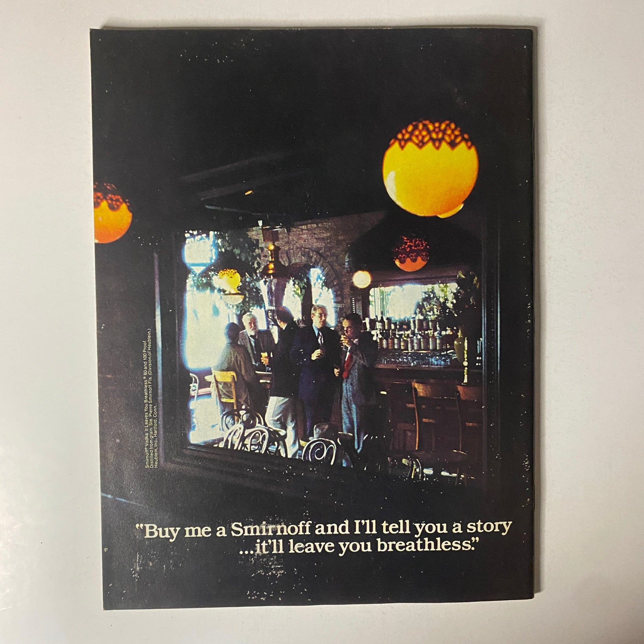 Back cover of Esquire Magazine March 1, 1978 with an image of people in a bar and the quote, 'Buy me a Smirnoff and I'll tell you a story...it'll leave you breathless.'