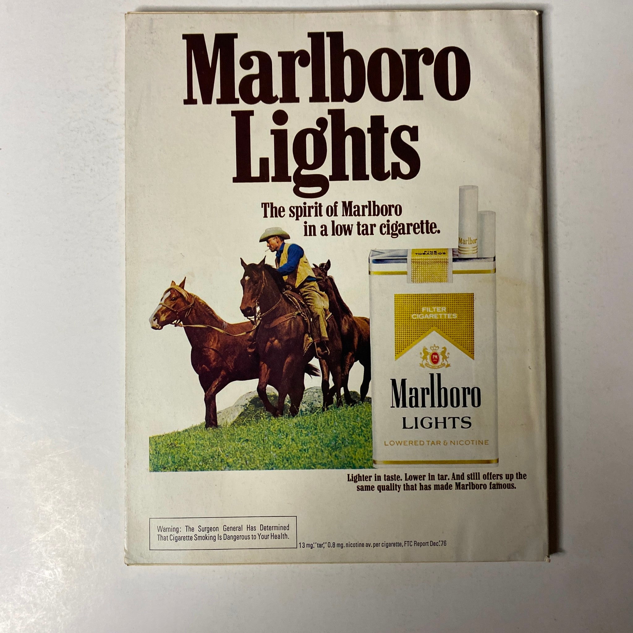 An advertisement from Esquire Magazine August 1977 for Marlboro Lights, showcasing the product alongside images of cowboys, reflecting the marketing strategies of the time.
