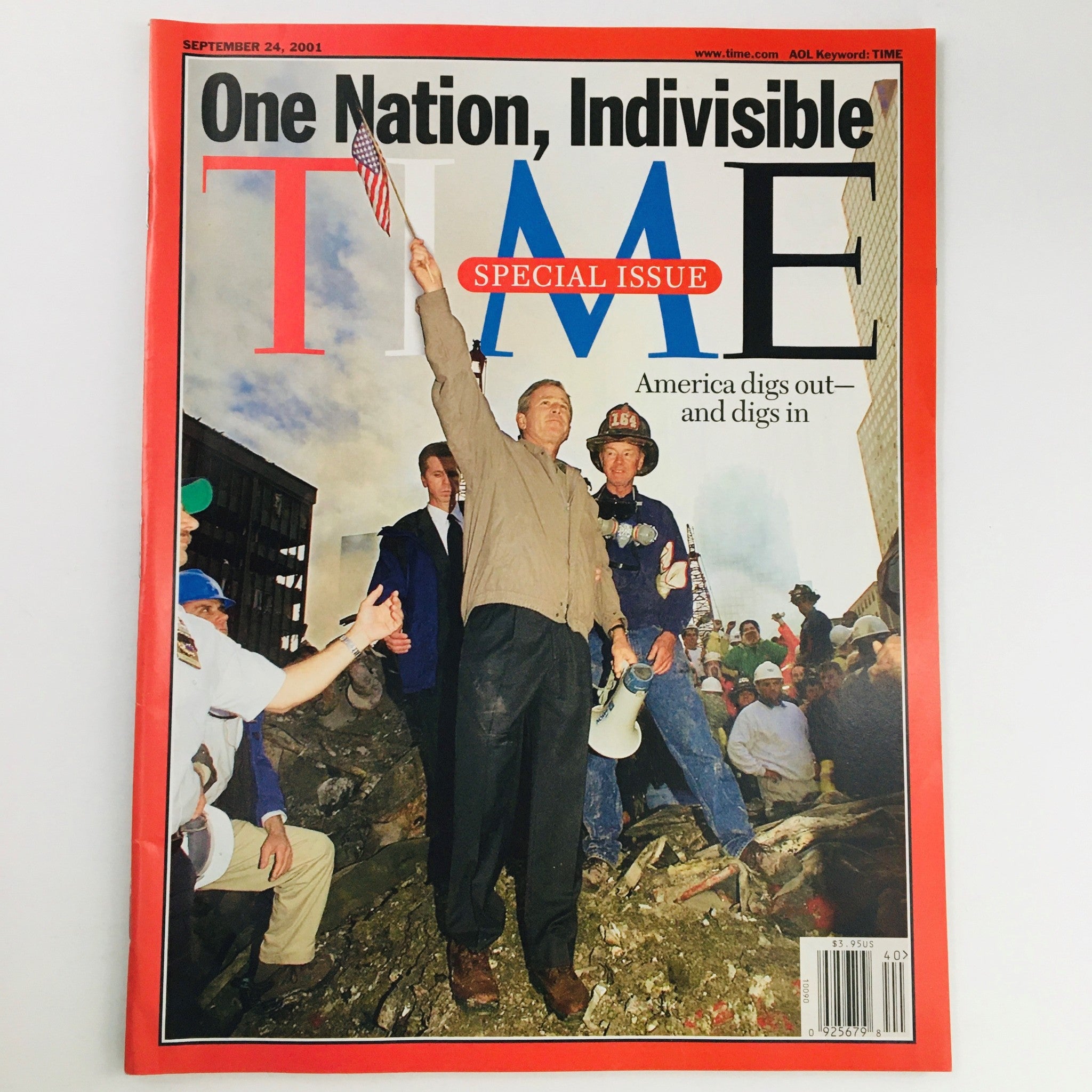 Cover of Time Magazine from September 24, 2001, titled 'One Nation, Indivisible', featuring President George W. Bush at a recovery site, symbolizing American resilience and unity following the September 11 attacks.