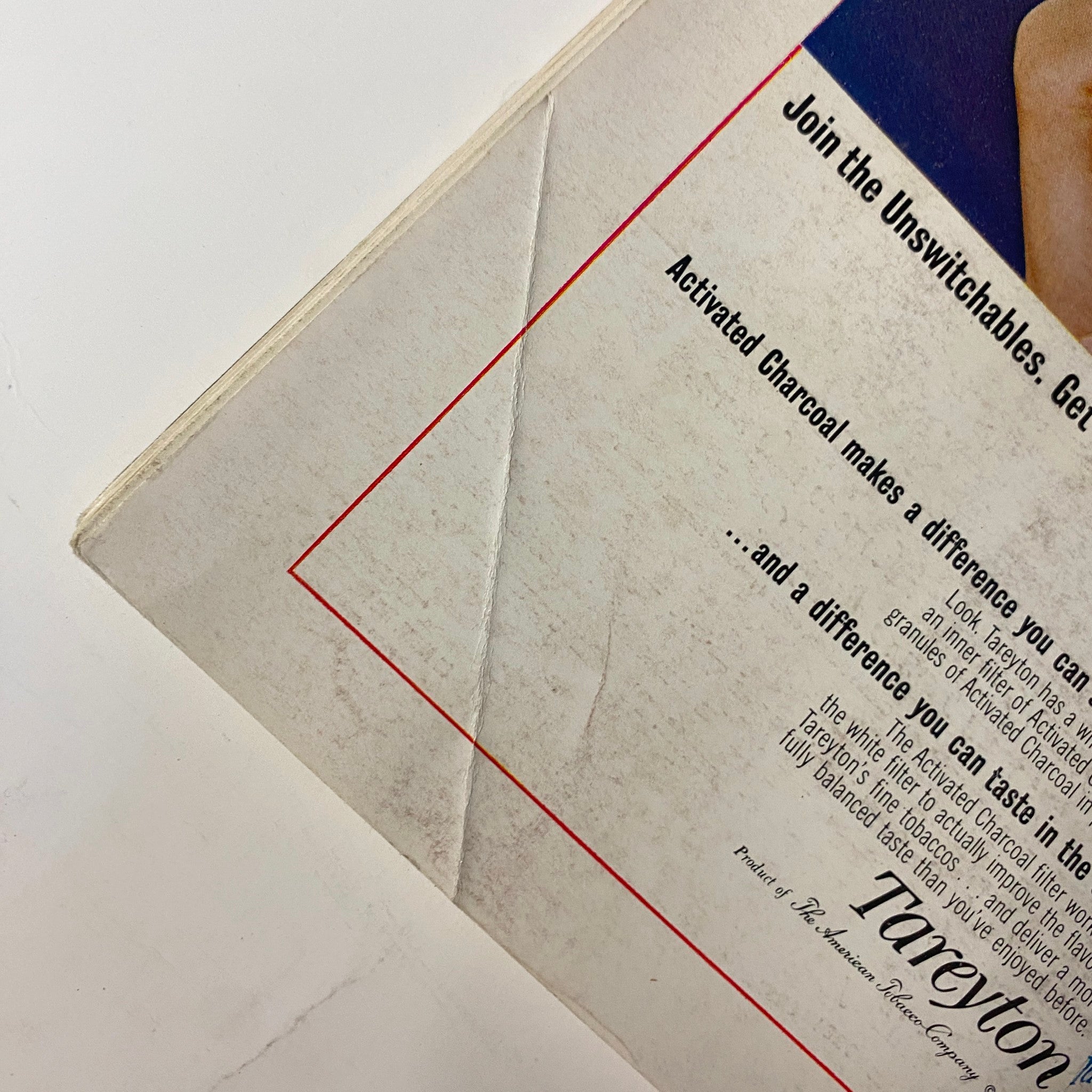 Close-up detail of the Tareyton cigarette advertisement on the back cover of Playboy Magazine November 1964, highlighting text about the activated charcoal filter and its benefits for smokers.