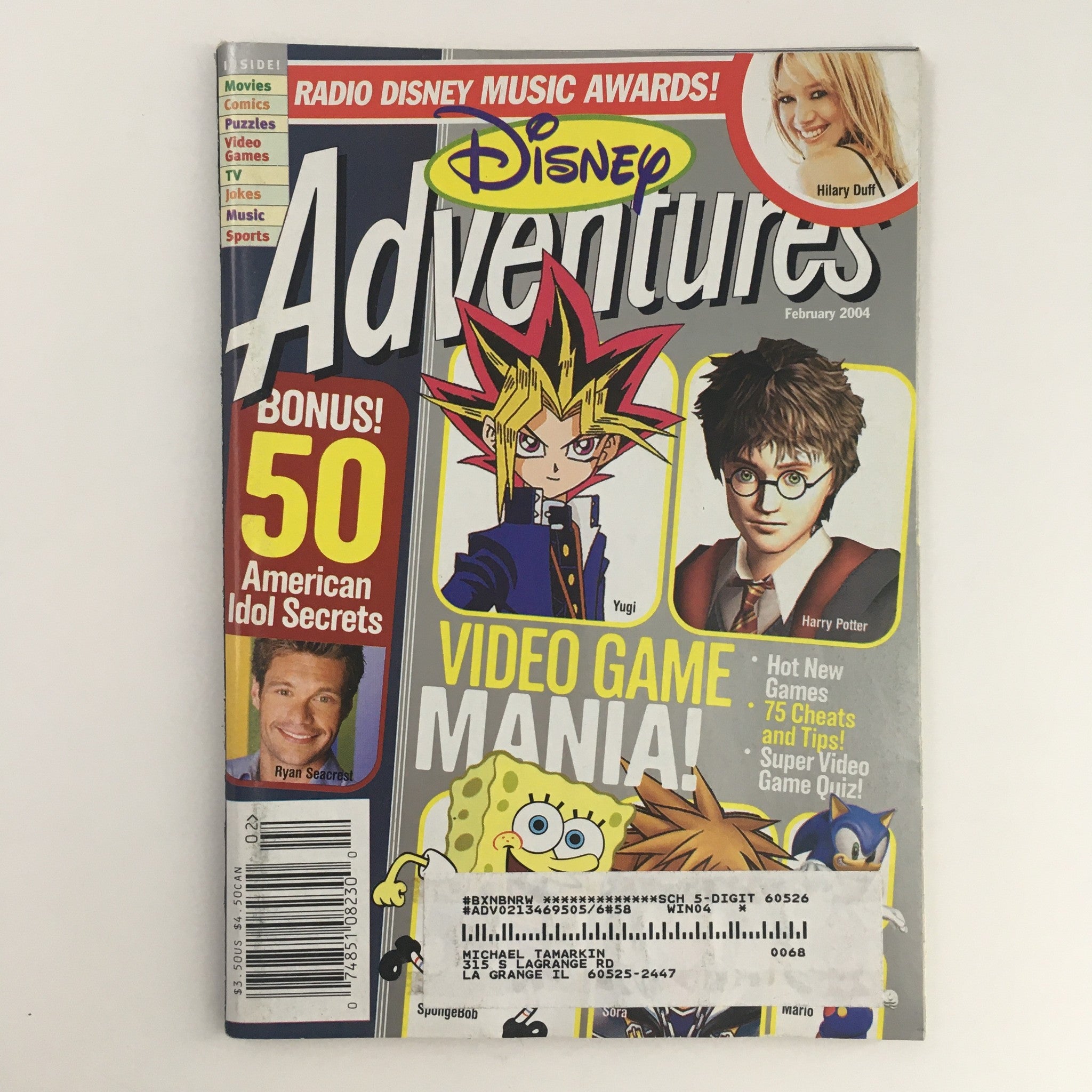 Cover of Disney Adventures Magazine February 2004 featuring pop icons Hillary Duff and Daniel Radcliffe, with special highlights on video games and American Idol secrets.