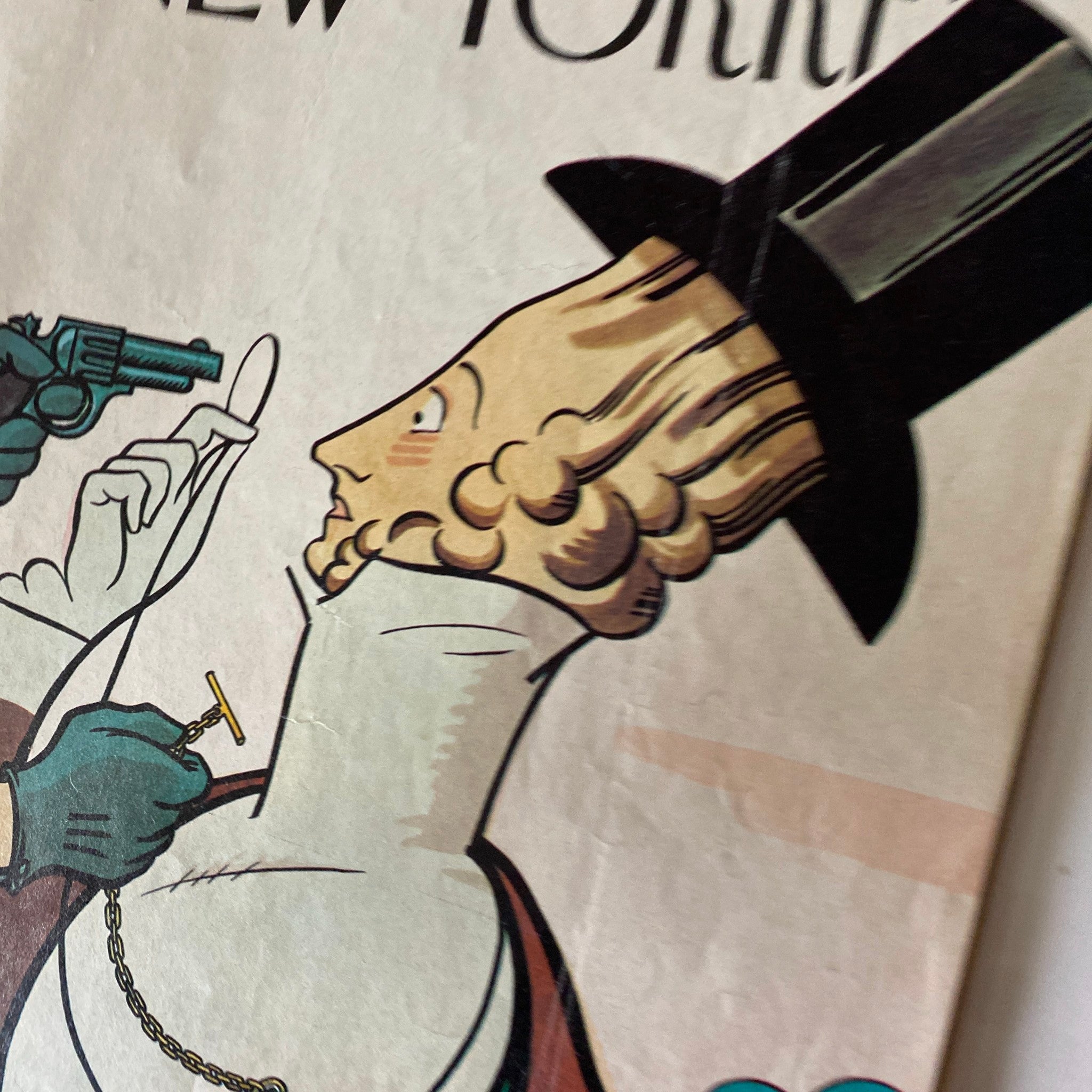 Close-up image of The New Yorker magazine cover from February 21, 1977, highlighting the illustration of a hand with a gun aiming at a character with a unique hairstyle, symbolizing artistic commentary.