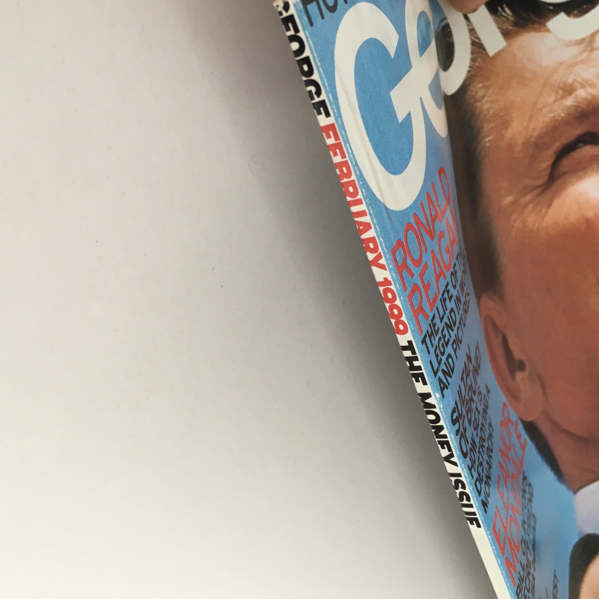 Side view of the George Magazine February 1999 cover displaying the title and elements related to Ronald Reagan, Eleanor Mondale, and political insights.