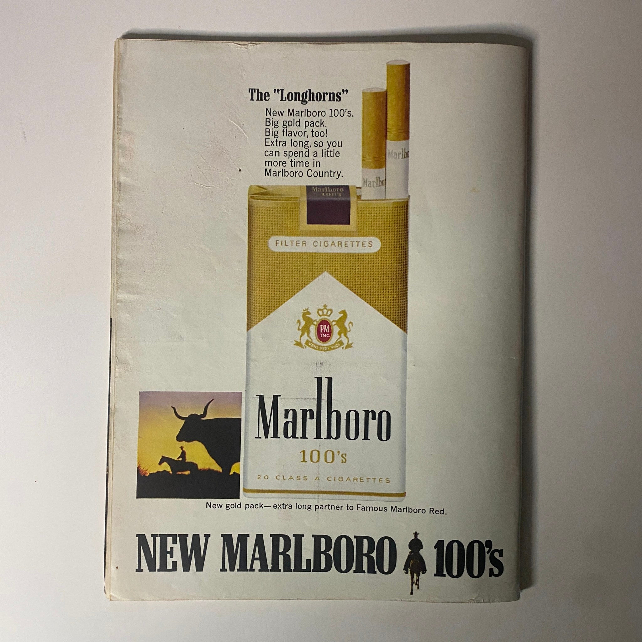 Advertisement for Marlboro 100's cigarettes featured in Time Magazine July 28, 1967, showcasing the new gold pack.