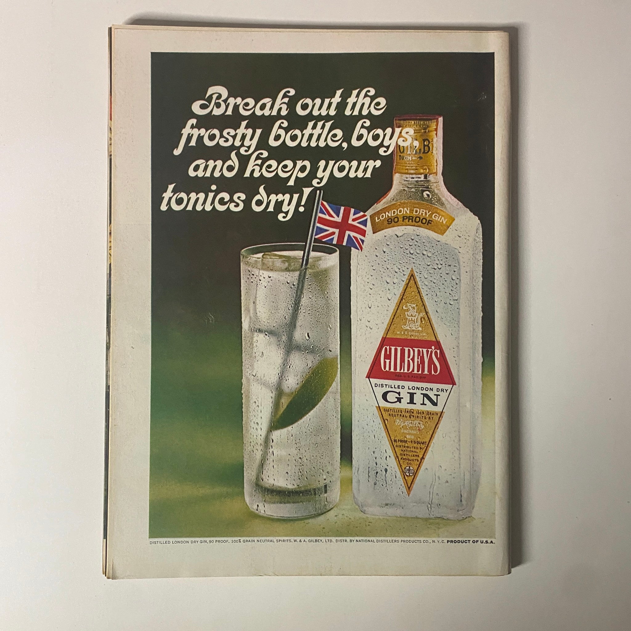 Advertisement for Gilbey's Gin featured in Time Magazine September 8, 1967 showcasing a glass of gin and tonic with a British flag, promoting a celebratory drink.