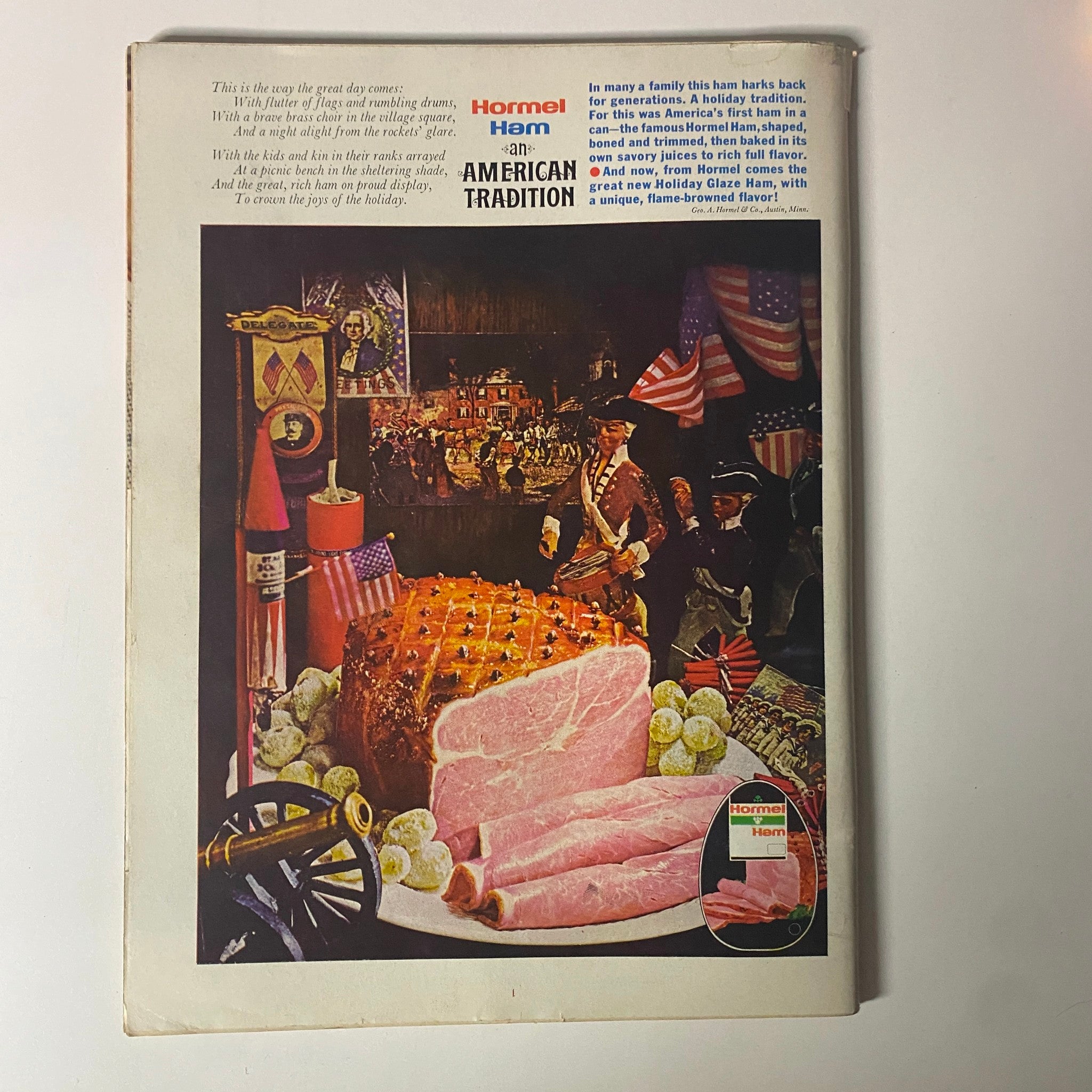 Vintage advertisement featuring Hormel Ham, titled 'Hormel Ham - an American Tradition', showcasing a festive scene with ham and decorations symbolizing American holidays, along with illustrations of American soldiers and festive elements.