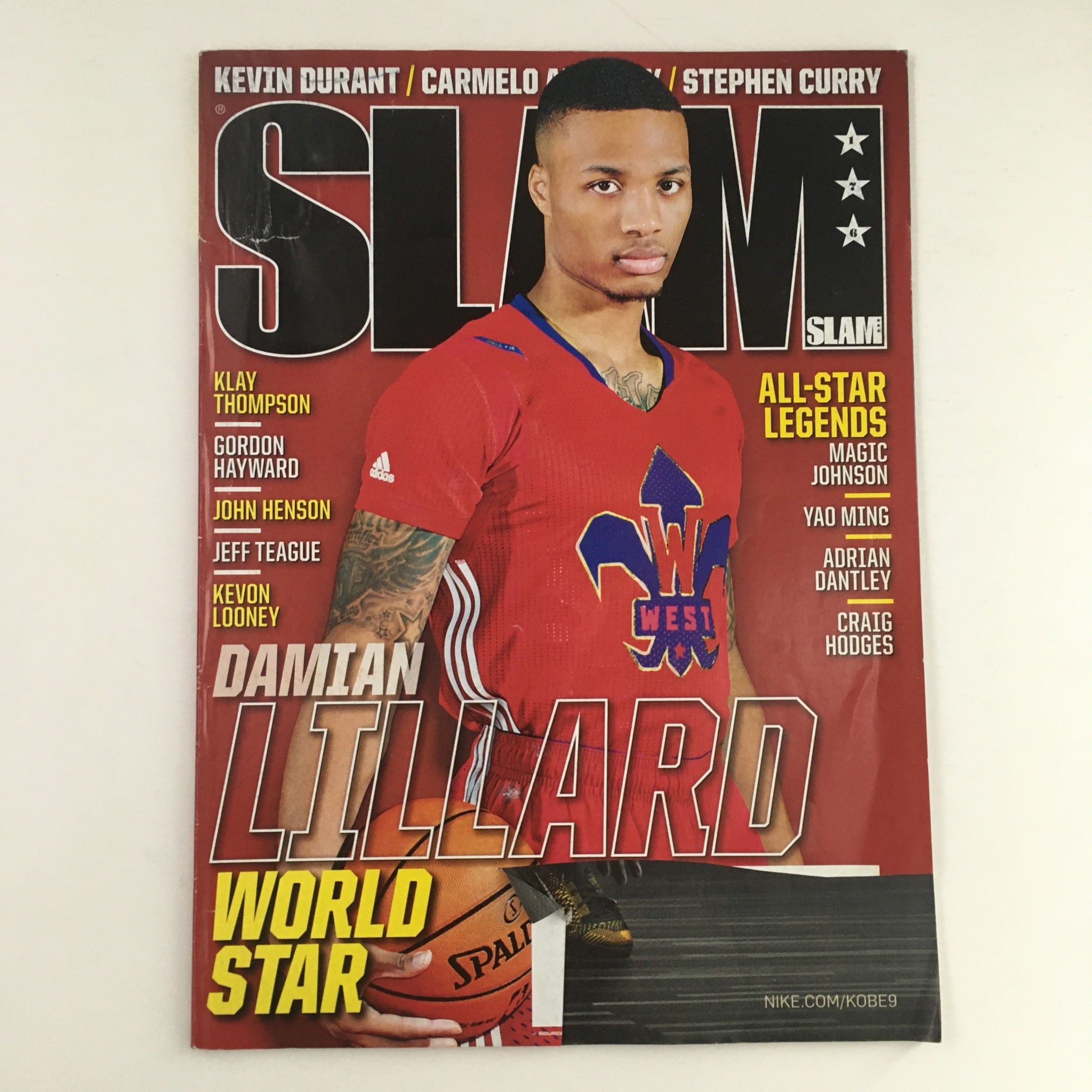 Slam Magazine April 2014 #176 featuring NBA Trail Blazers' Damian Lillard on the cover, showcasing him in a red jersey, highlighting his status as a world star in basketball.
