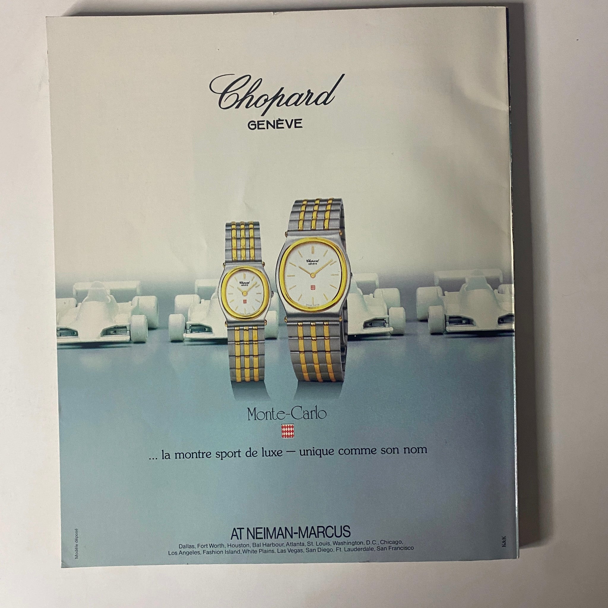 Advertisement for Chopard watches in Connoisseur Magazine March 1986, showcasing luxury timepieces against a backdrop of racing cars.