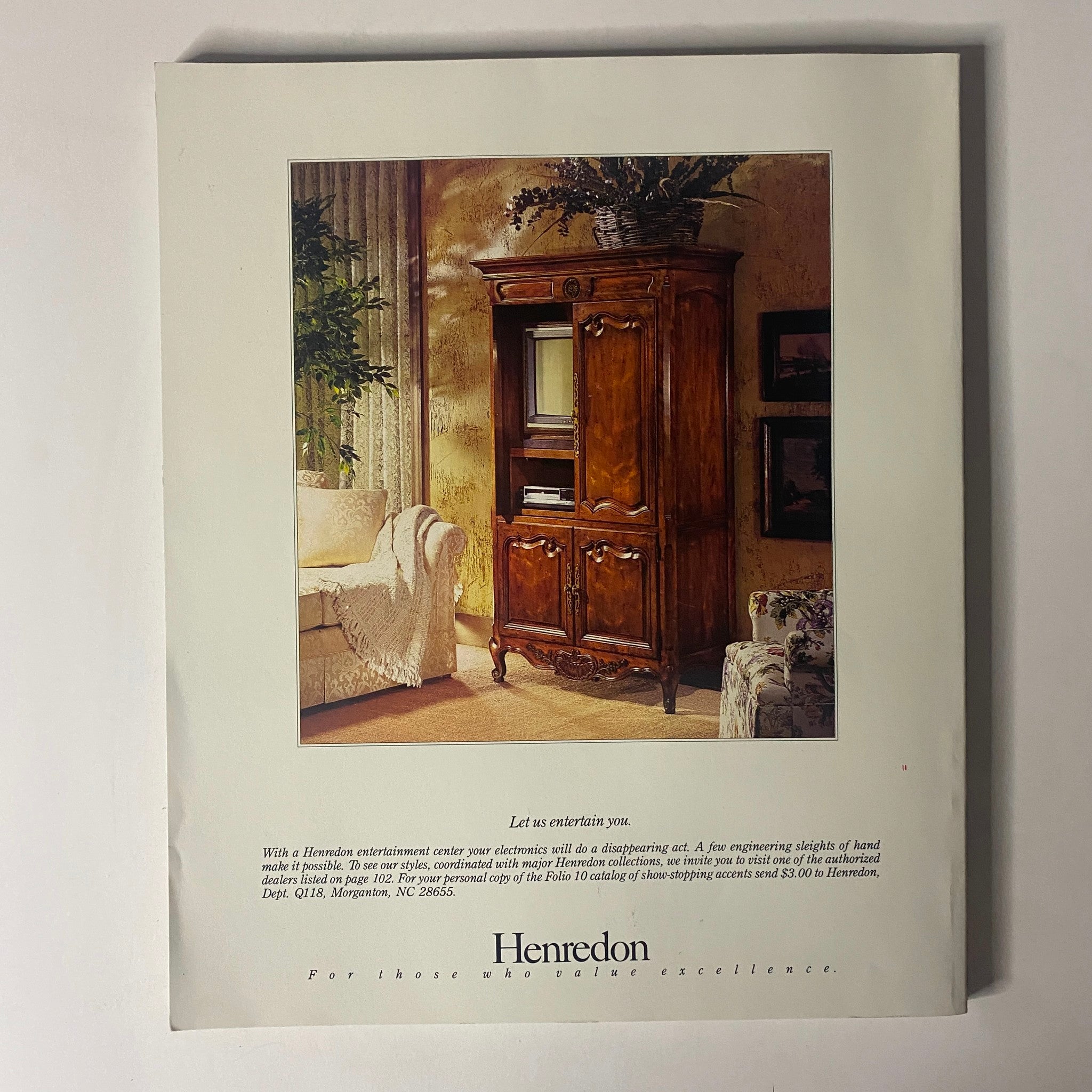 Vintage advertisement for Henredon showcasing a wooden entertainment center in an elegantly decorated living room, featured in Connoisseur Magazine November 1988.
