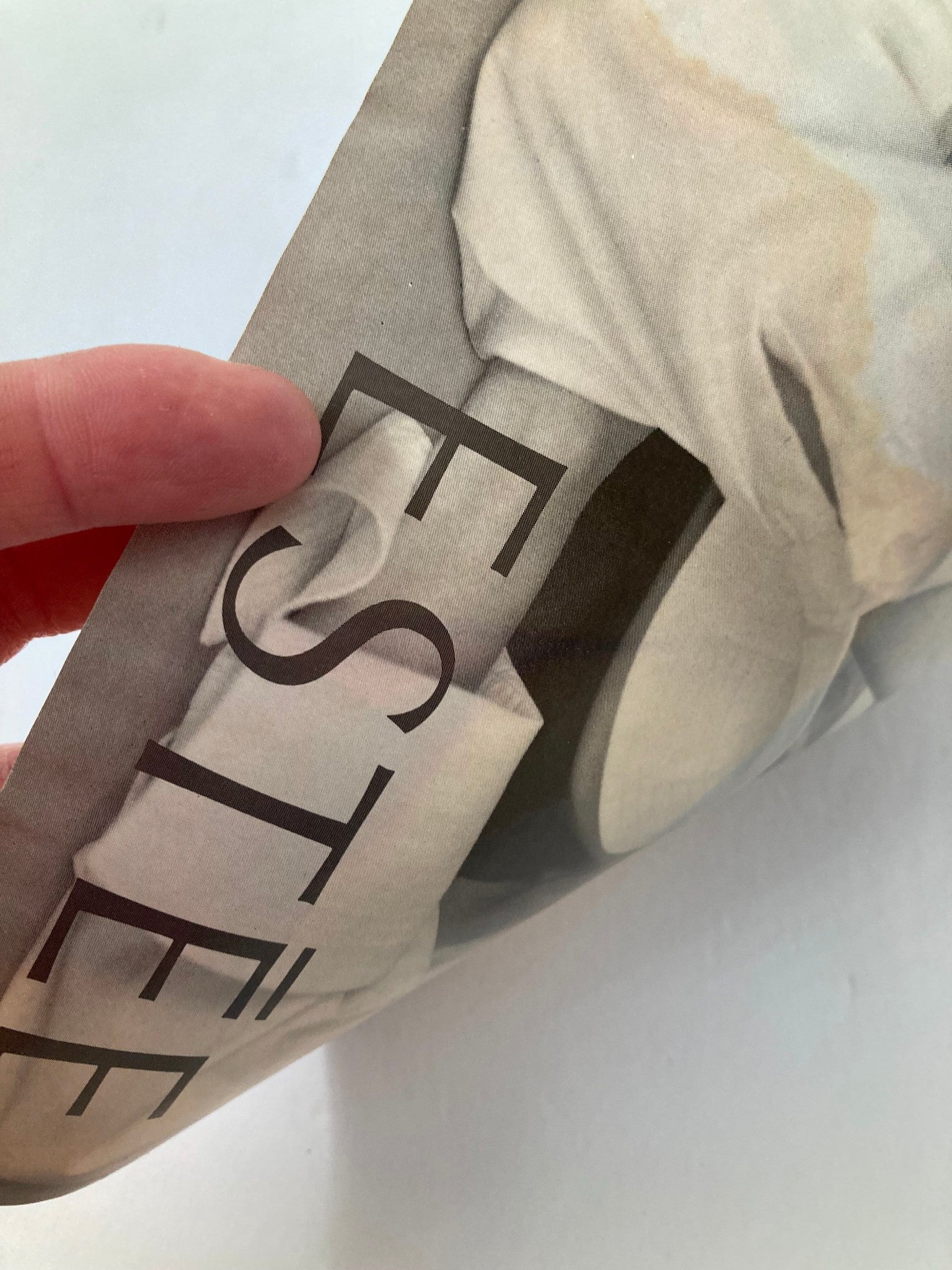 Close-up image of a magazine page showing text and partially visible photo. The layout suggests it is part of a fashion feature, contributing to the vintage aesthetic.
