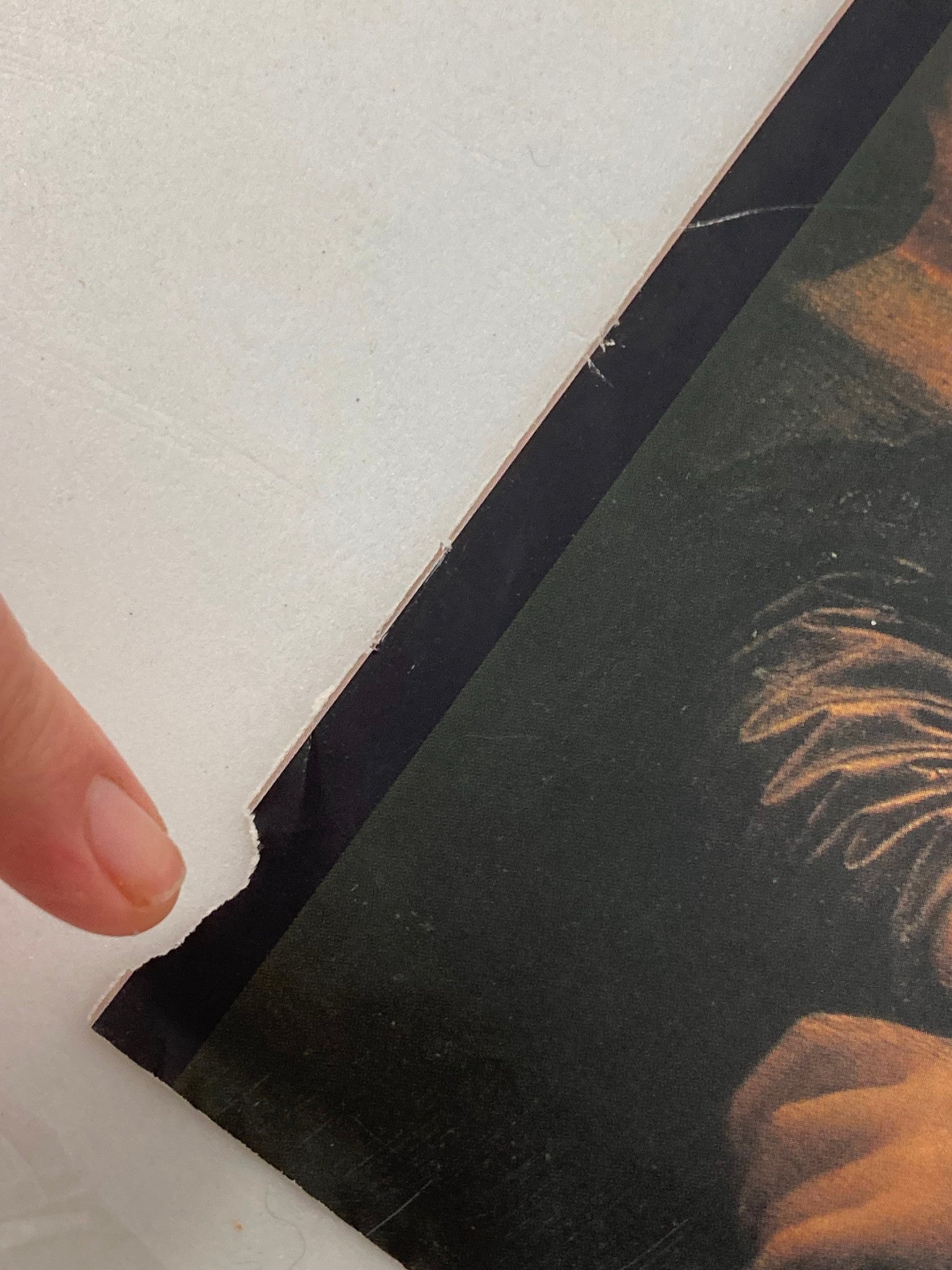 Close-up of the bottom corner of The New Yorker February 8, 1999 cover, displaying damage, emphasizing the collectible nature and history of the magazine cover featuring Monica Lewinsky.