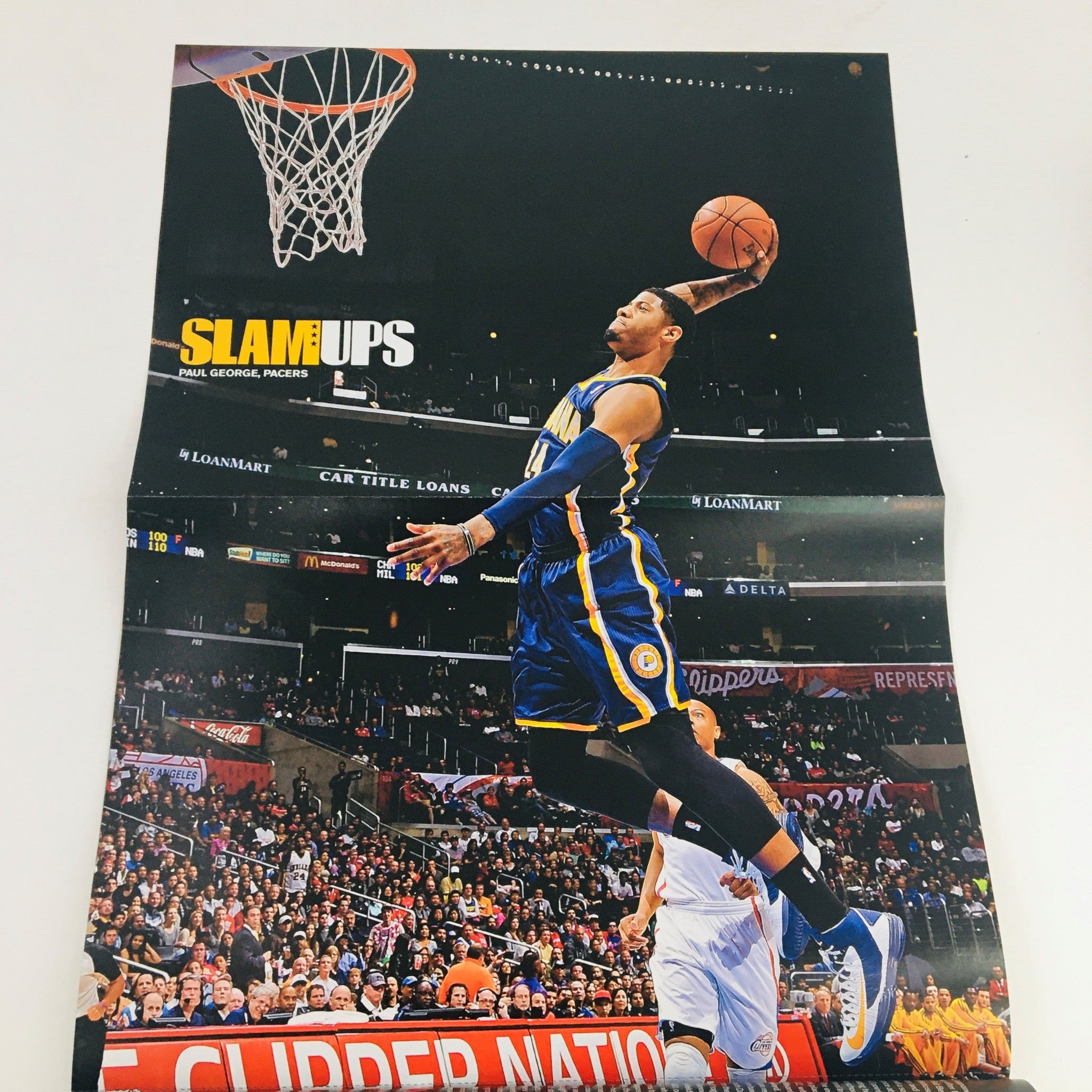 Poster from Slam Magazine November 2013 featuring Paul George in a game action shot during a basketball match.