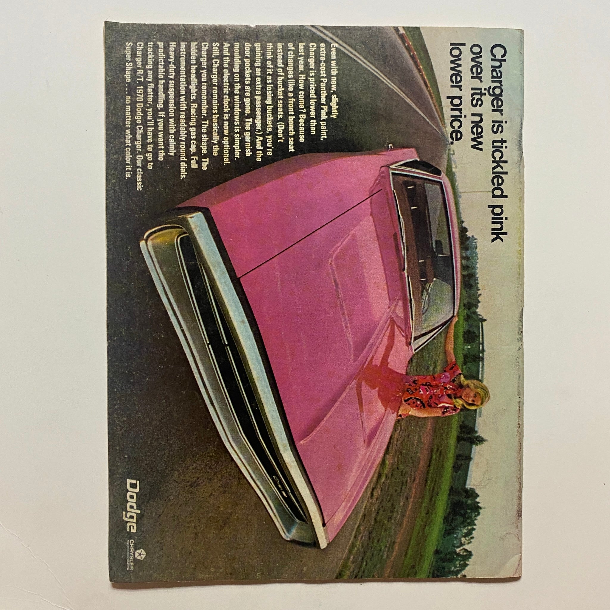 Back cover of VTG Motorcade Magazine July 1970 showcasing a Dodge Charger advertisement, emphasizing the vehicle's new lower price and design.