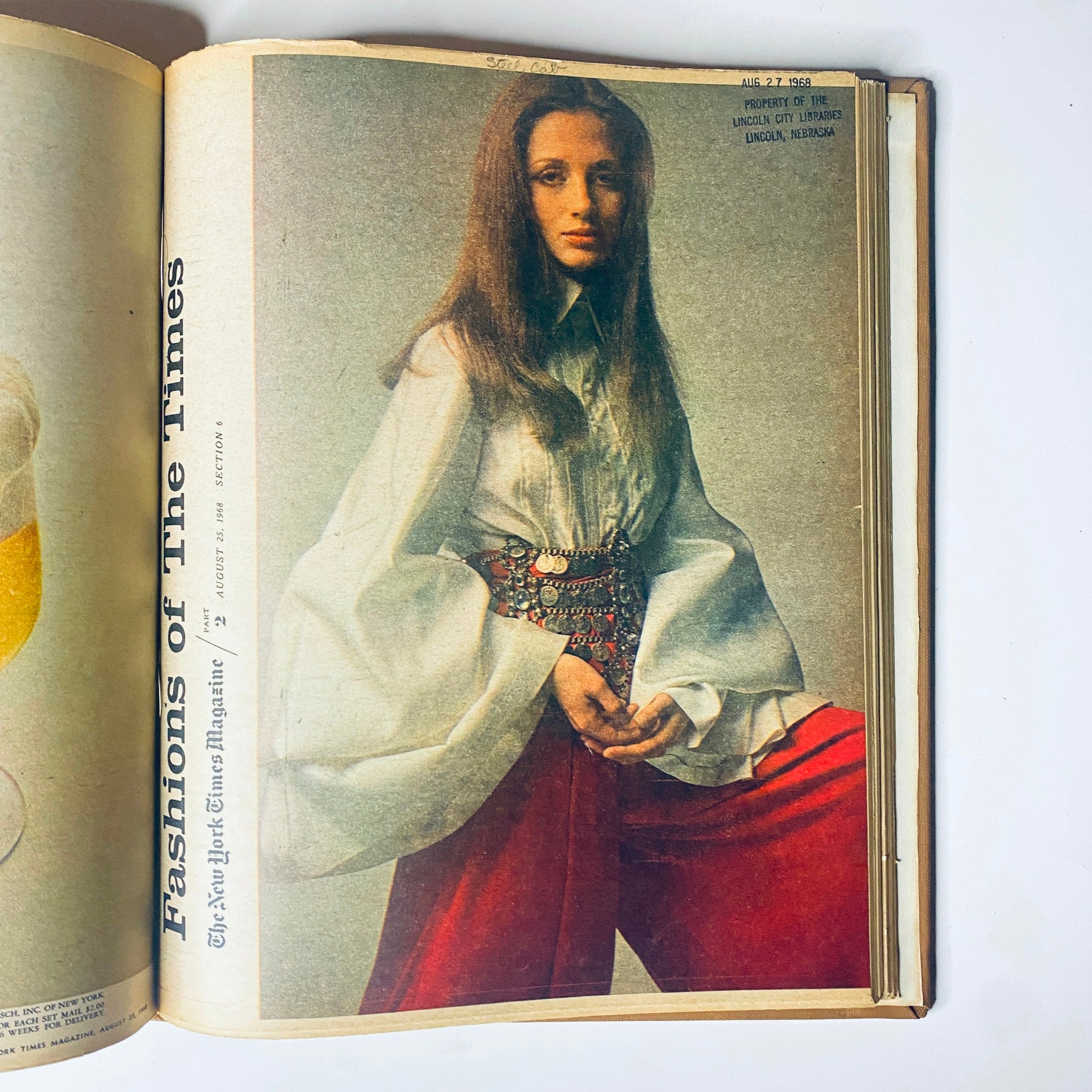 Fashions featured in The New York Times Library Edition Bound Magazine 1968 July - August, highlighting a model in a 1960s fashion ensemble with a bell-sleeved blouse and vibrant red trousers.