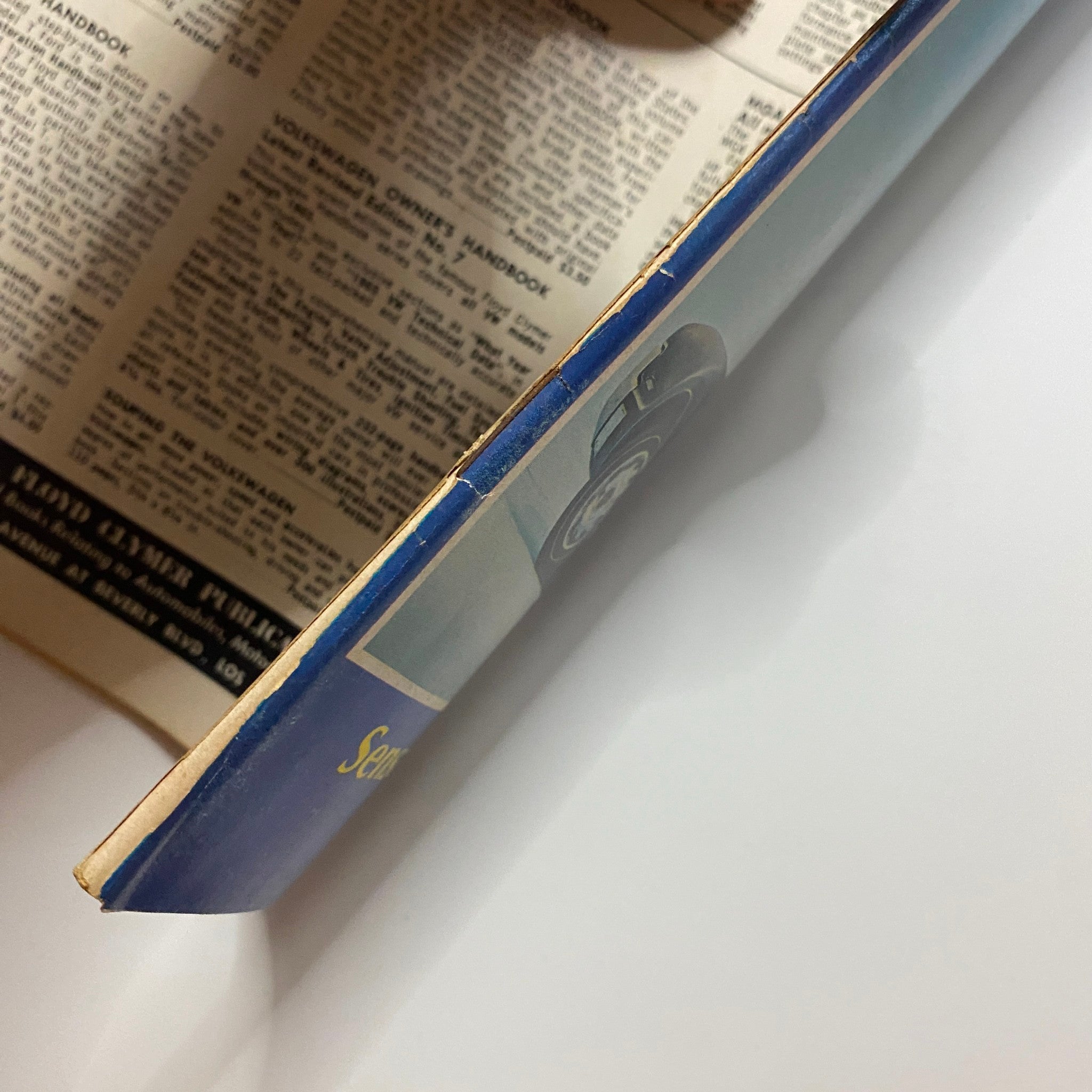 Side view of VTG Auto Topics Magazine December 1965 New Oldsmobile Toronado showcasing the spine and edge, highlighting vintage book design.