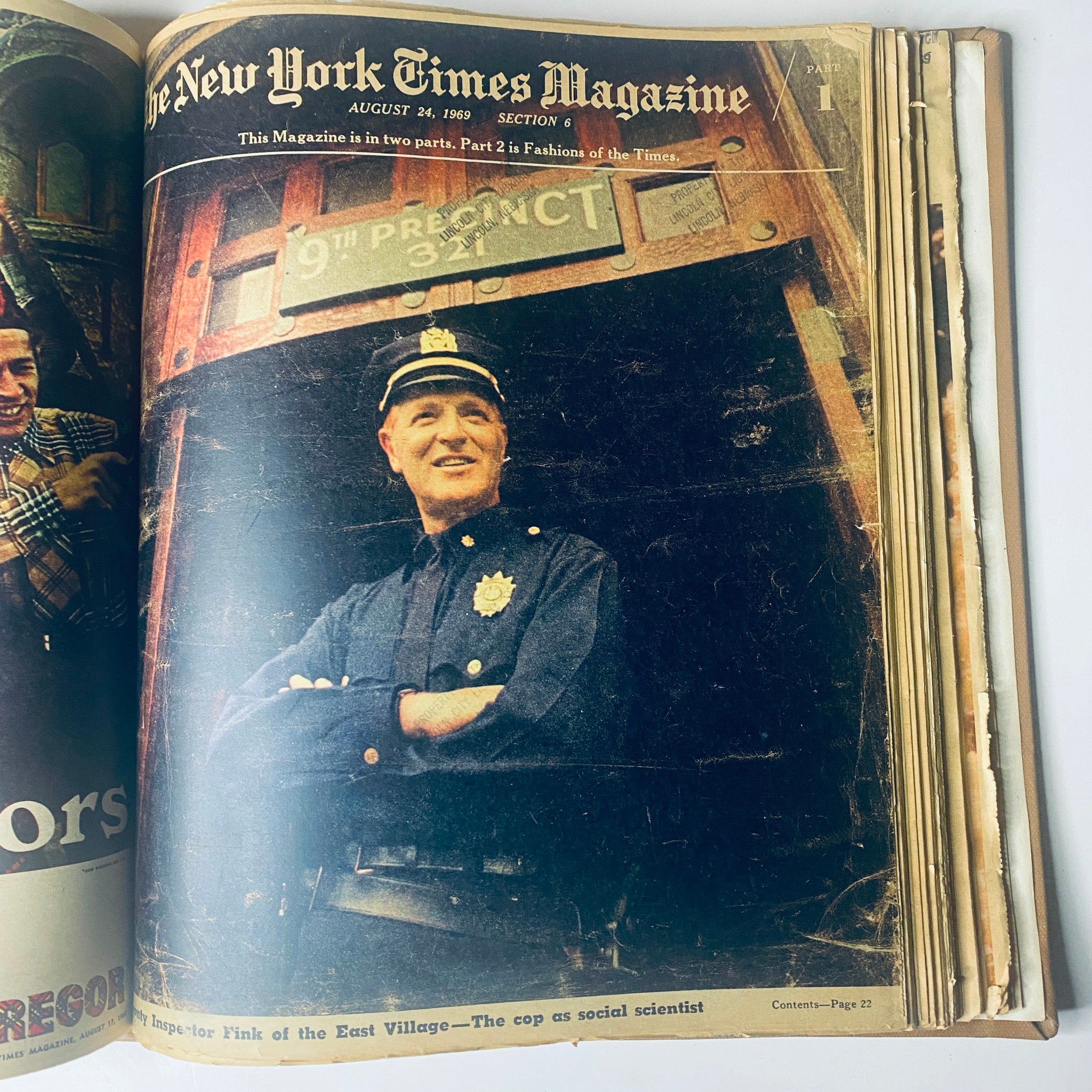 Cover of The New York Times Magazine, August 24, 1969, depicting a police officer smiling in front of a precinct sign, exploring themes around urban policing and community.