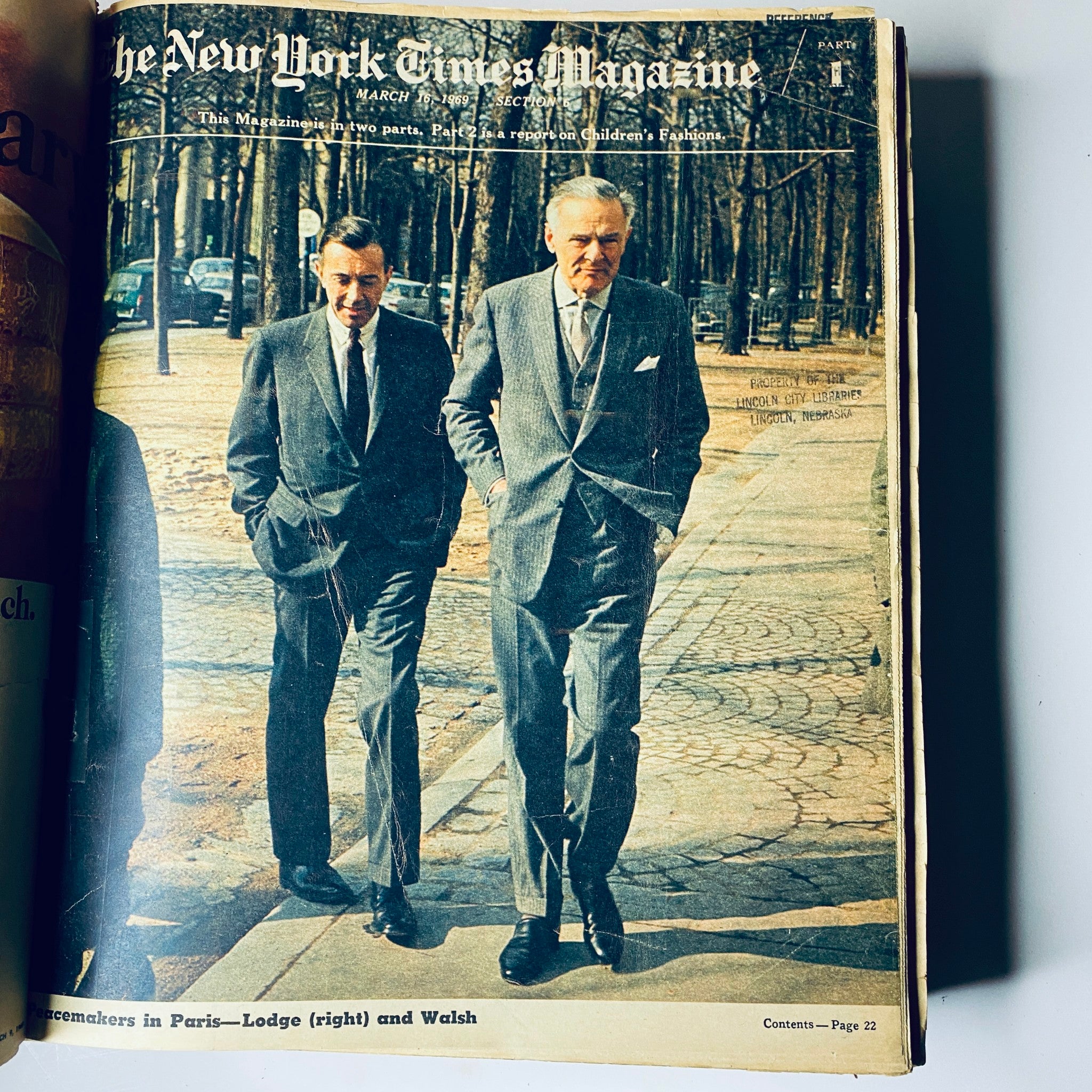 Cover of The New York Times Bound Magazine 1969 March - April featuring two men in suits walking in a park, symbolizing the business fashion landscape of the late 60s.