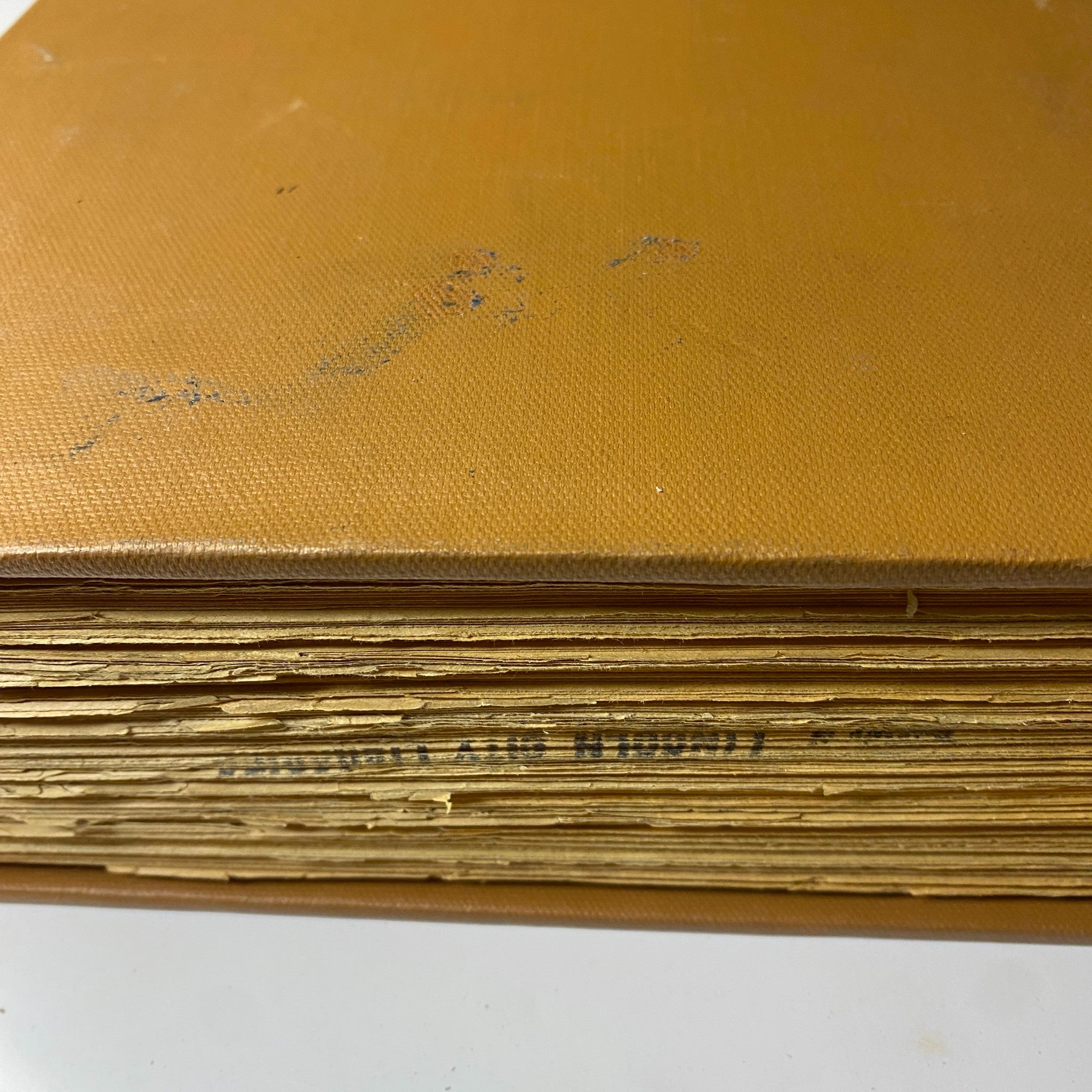 Close-up view of the edge of 'The New York Times Bound Magazine 1969 March - April' showing its well-bound condition with golden pages.