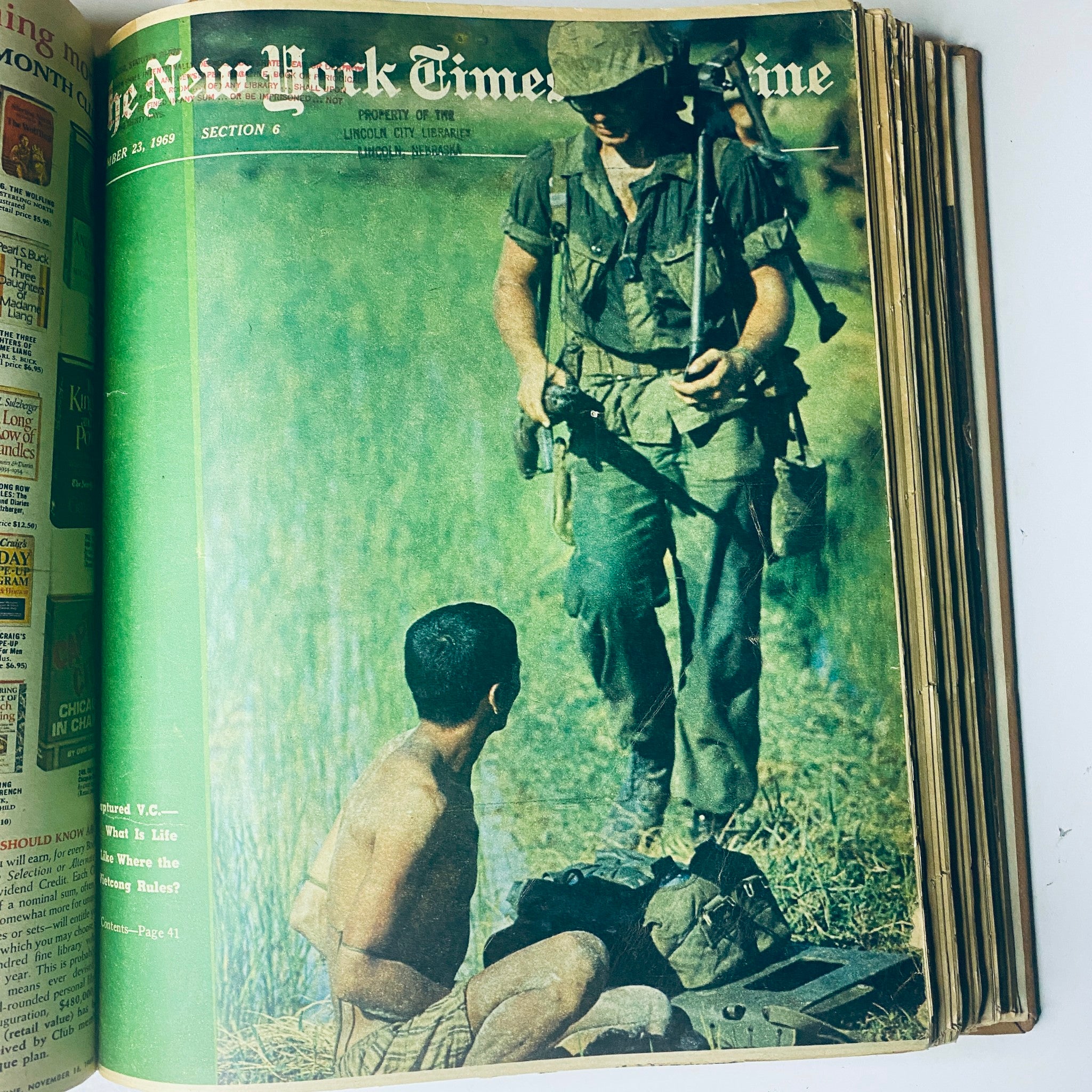 Cover of The New York Times Bound Magazine November 23, 1969, featuring a soldier and a child, reflecting on the cultural and political changes of the era.
